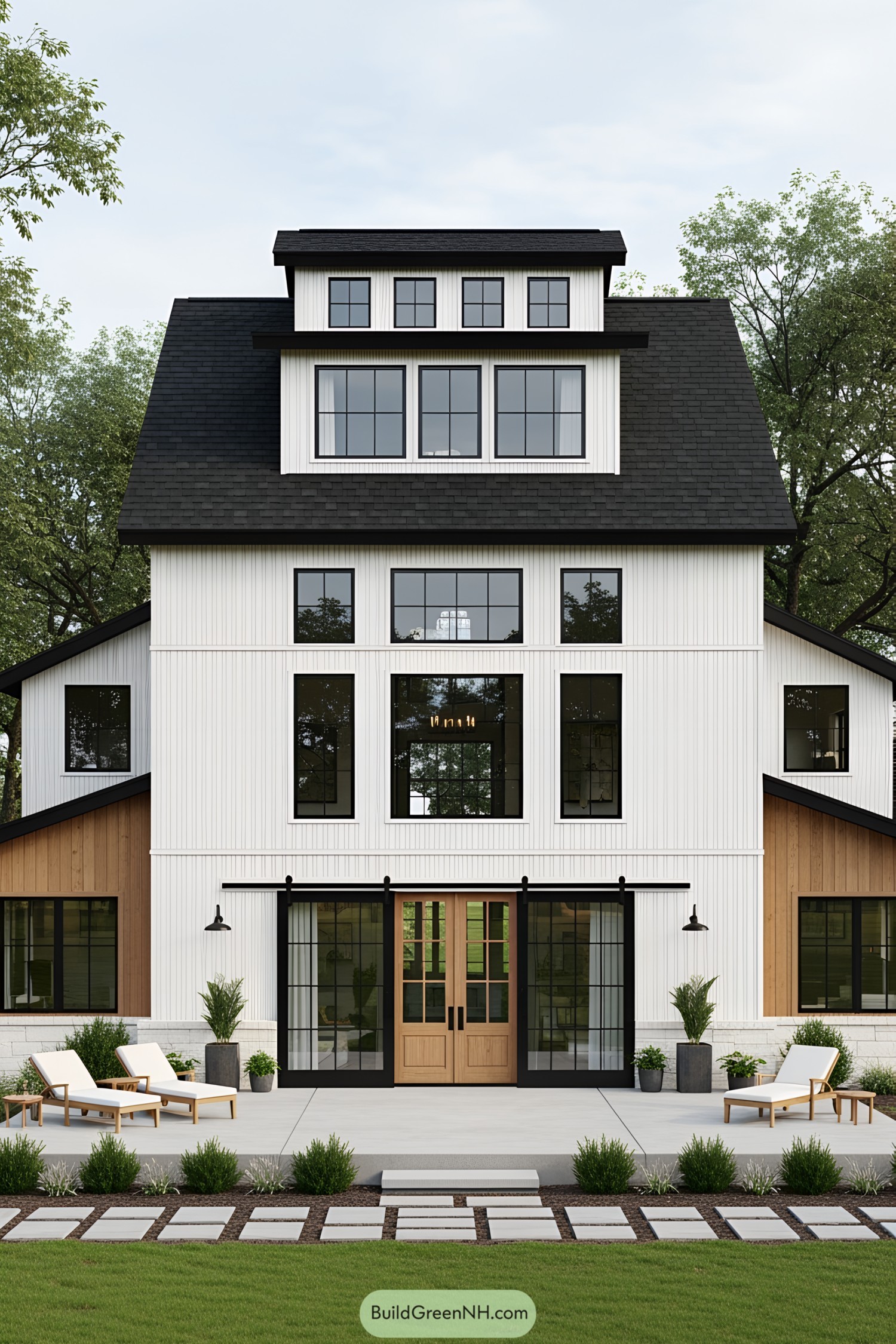 Exterior of a modern multi-level barndominium with white siding and large windows