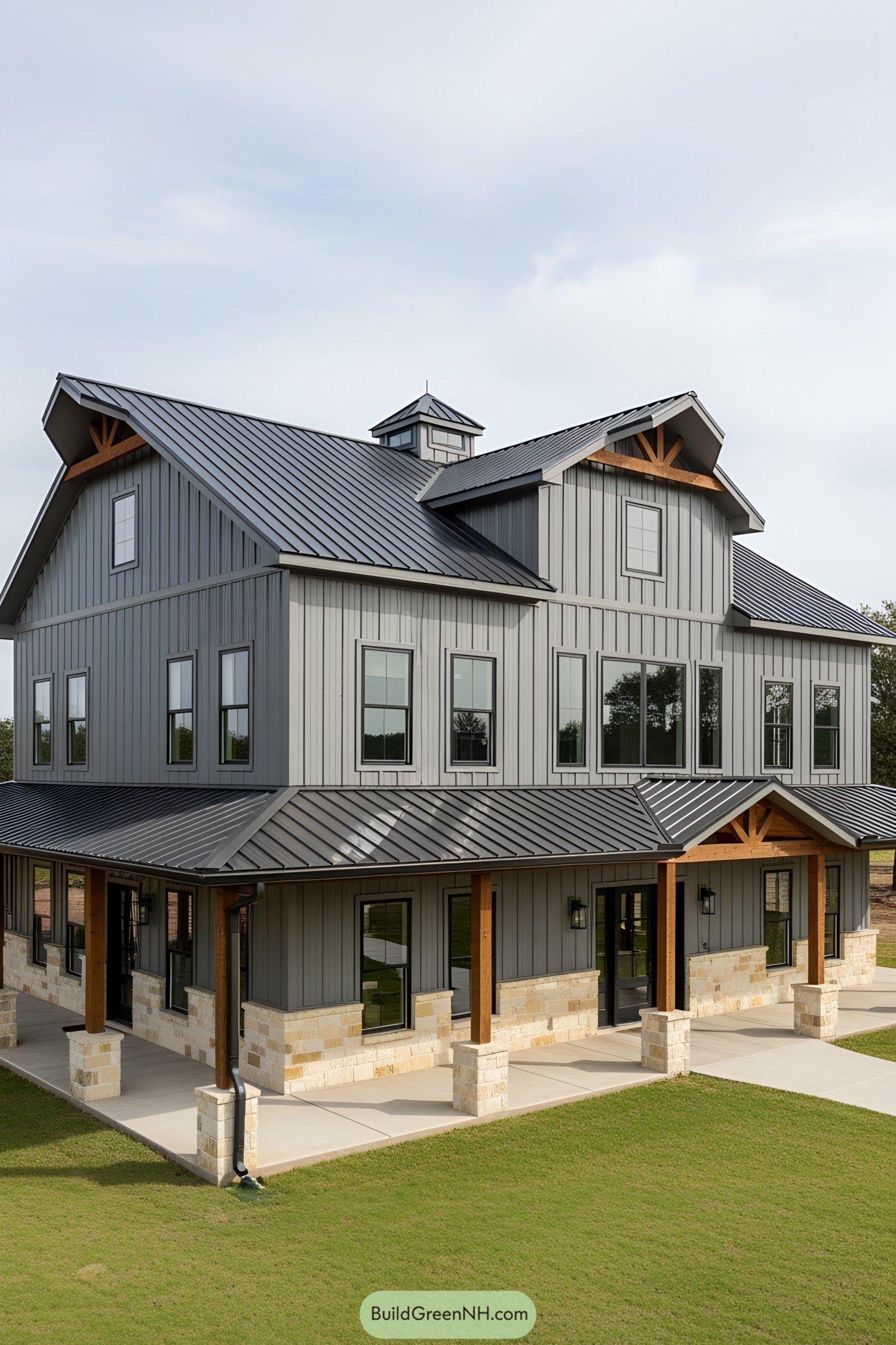 A modern multi-level barndominium with gray exterior and metal roof