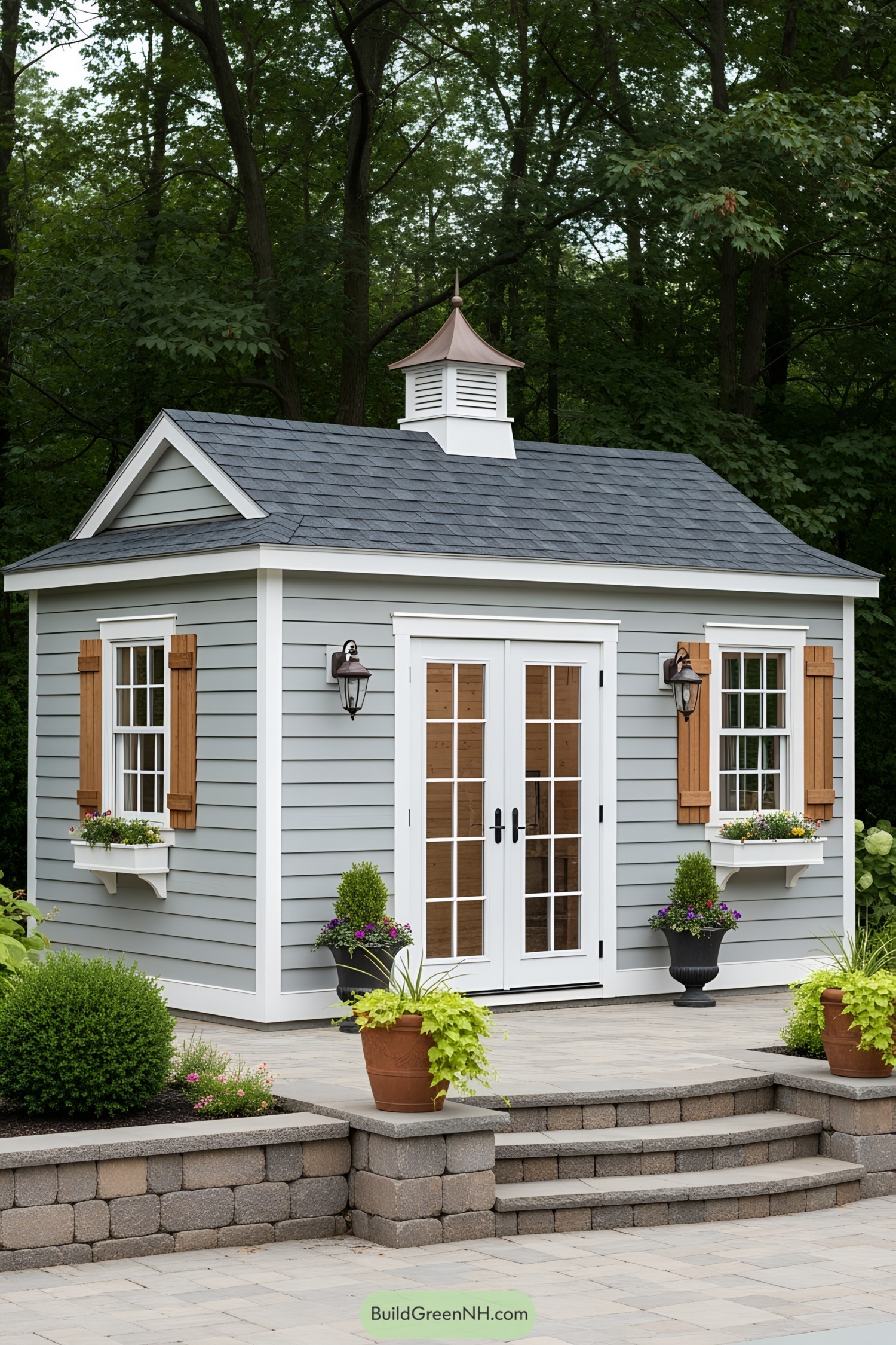 Charming small gray shed with brown shutters and white trim