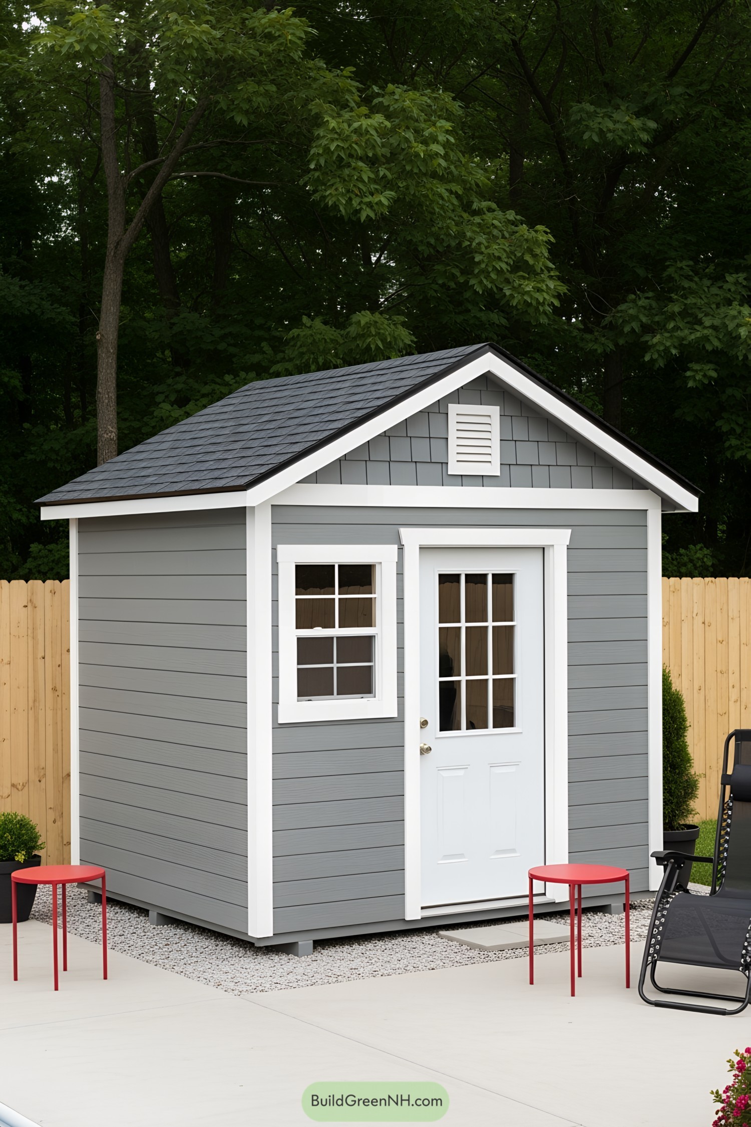 Gray pool house shed with a white door and red tables