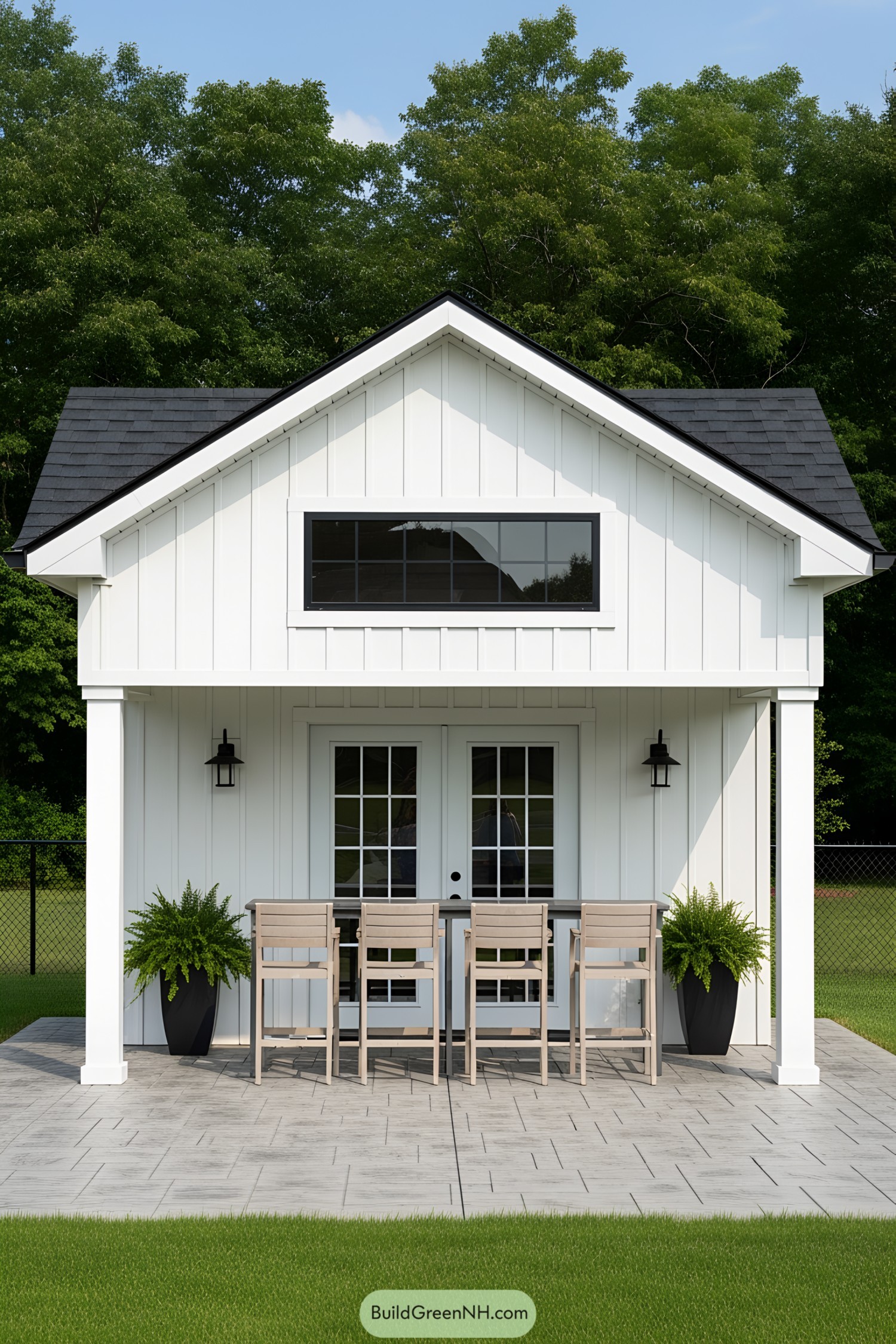 White pool house with tall windows and a cozy patio