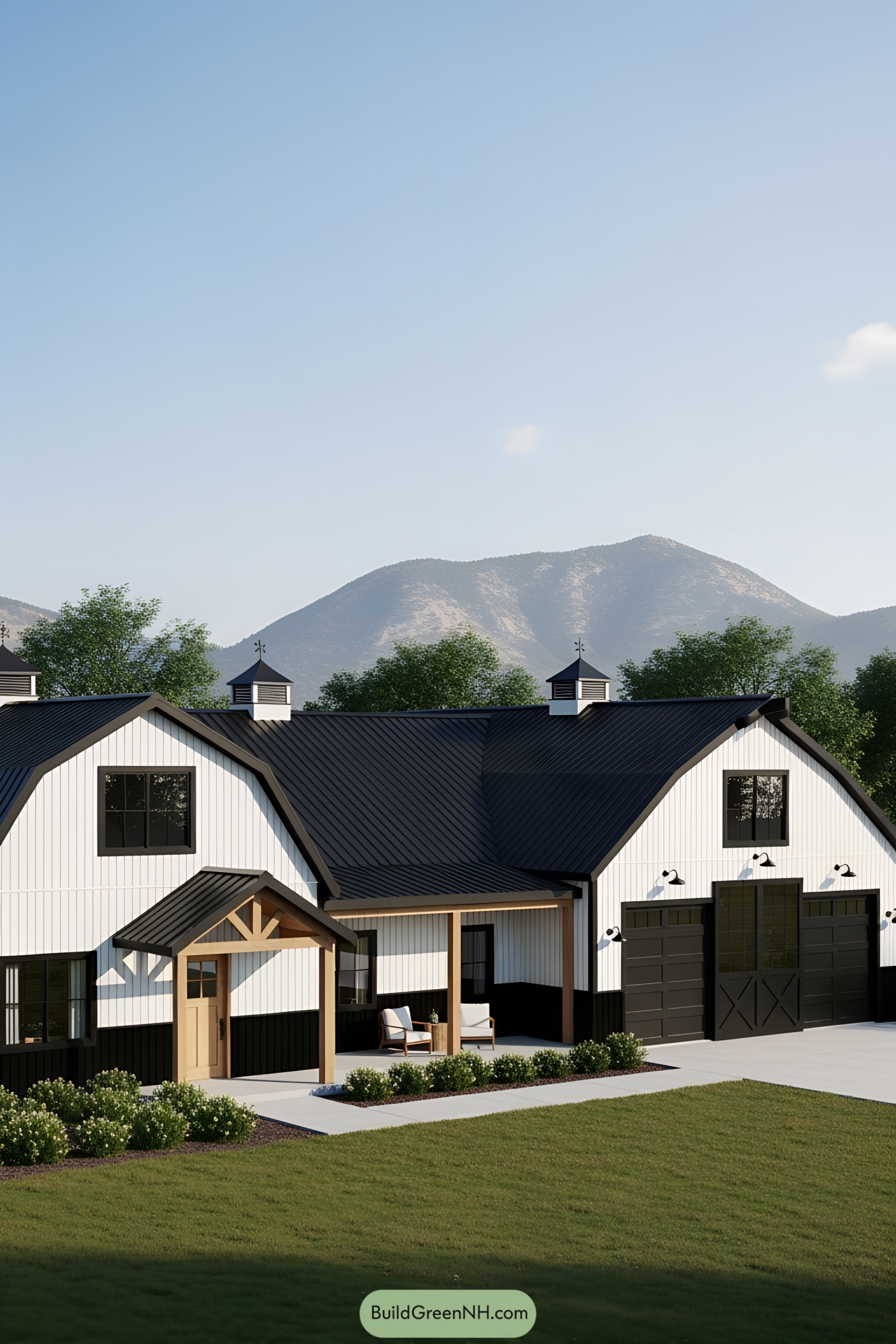 White barndominium with black accents and a mountain backdrop