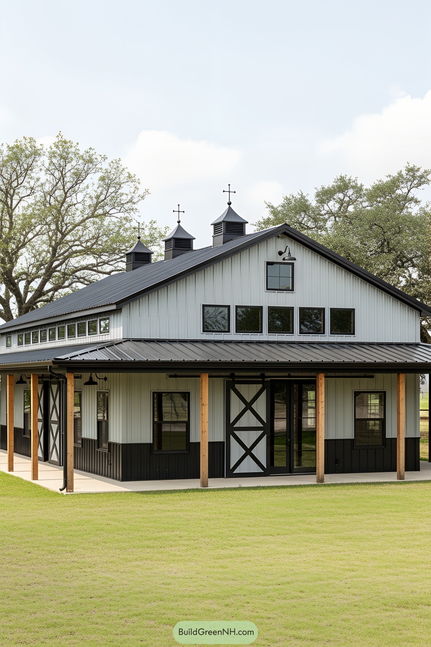 Modern barndominium with cupolas and large windows