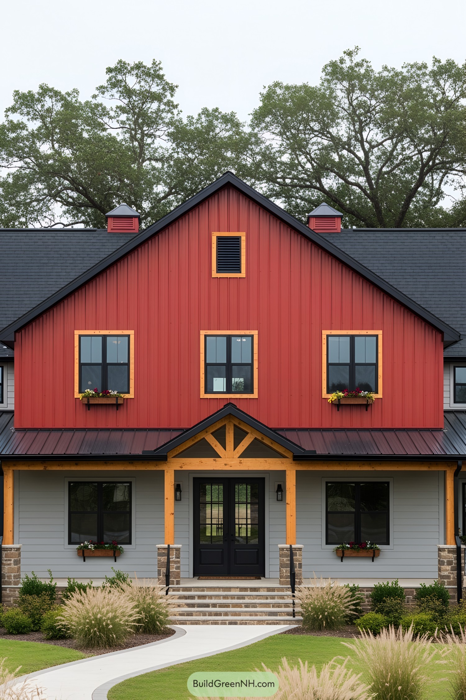 Red and Grey Barndominium with Black Roof Surrounded by Grass and Trees