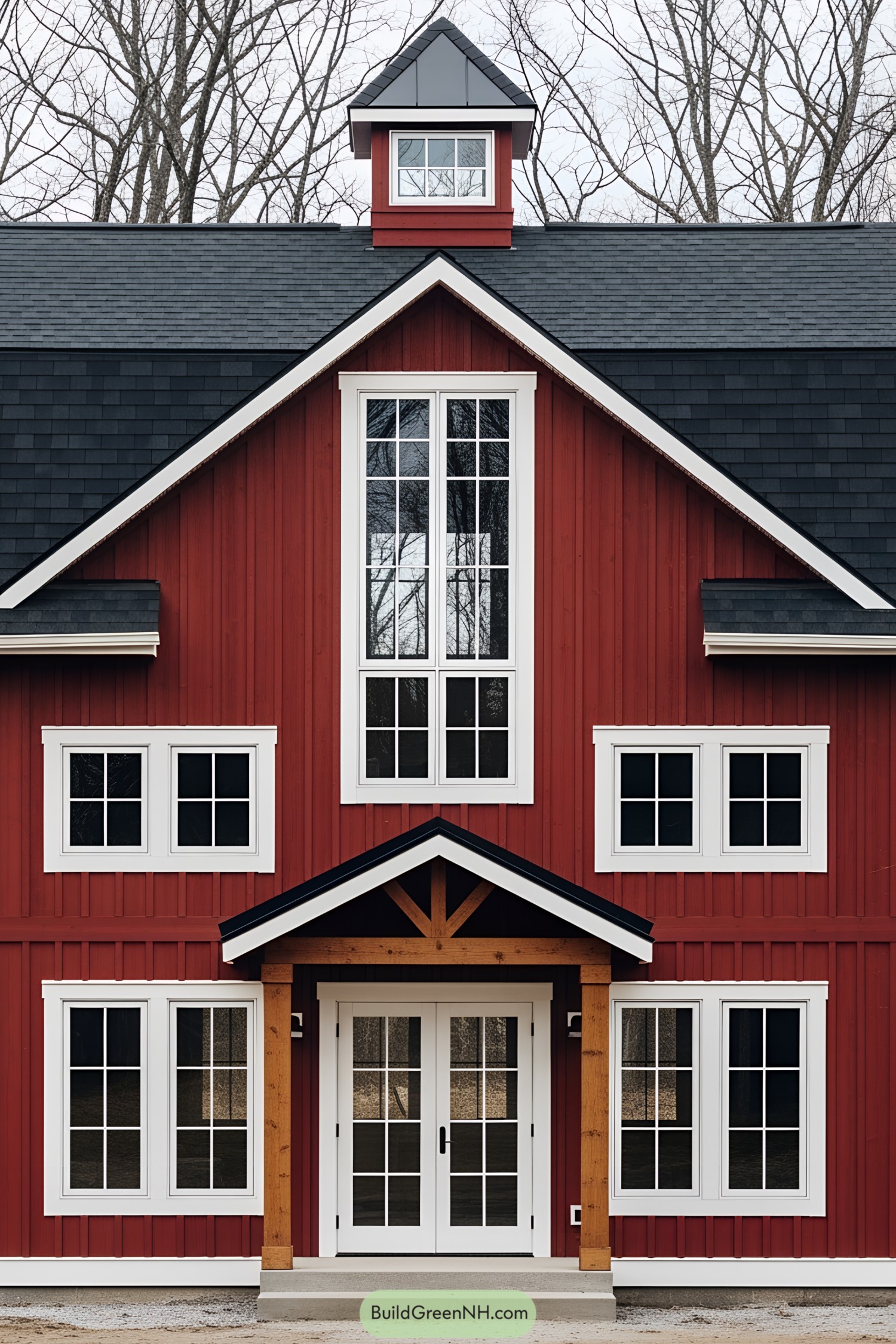 A vibrant red barn-style house with white-trimmed windows