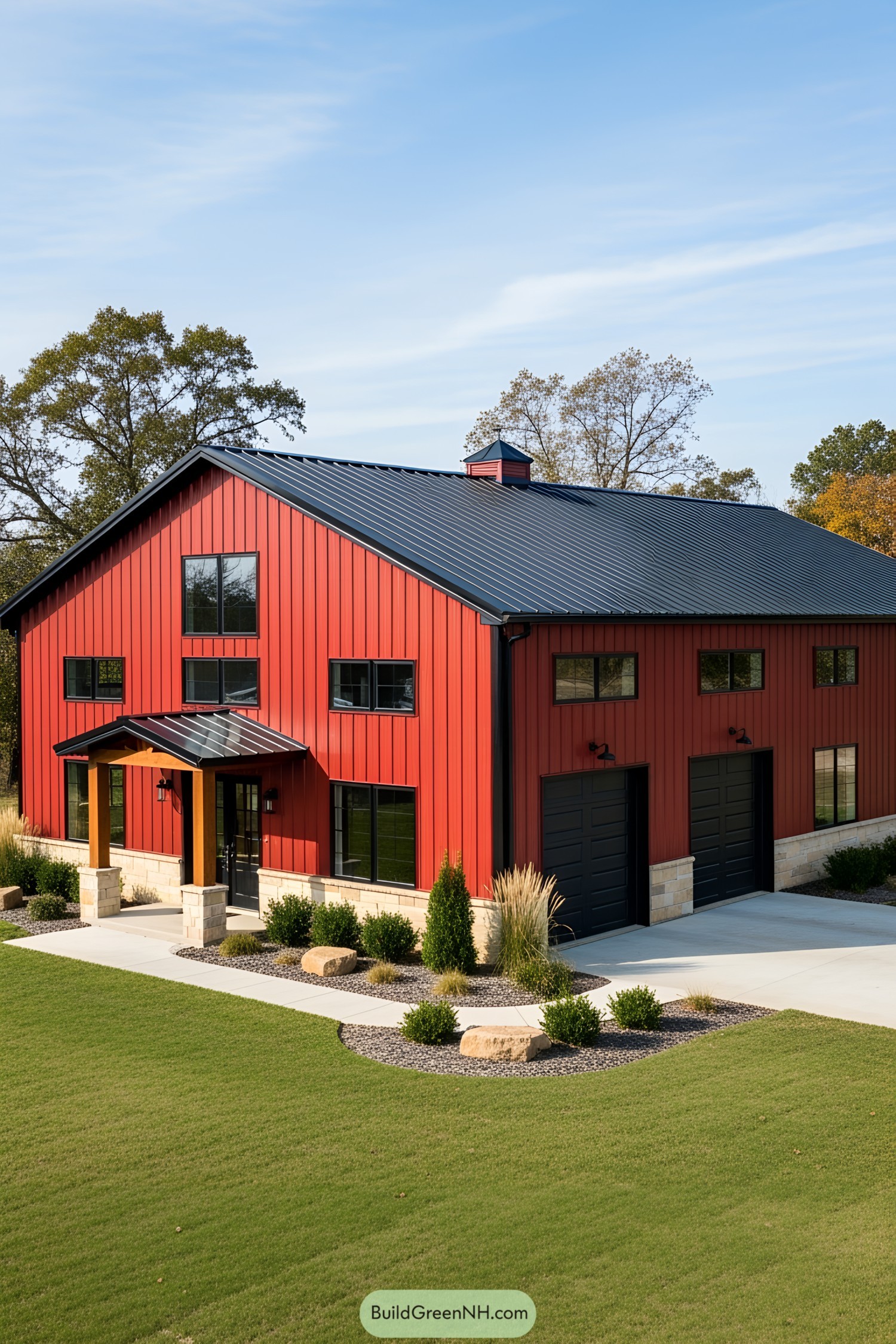 Red barndominium with black roof and dual garage doors