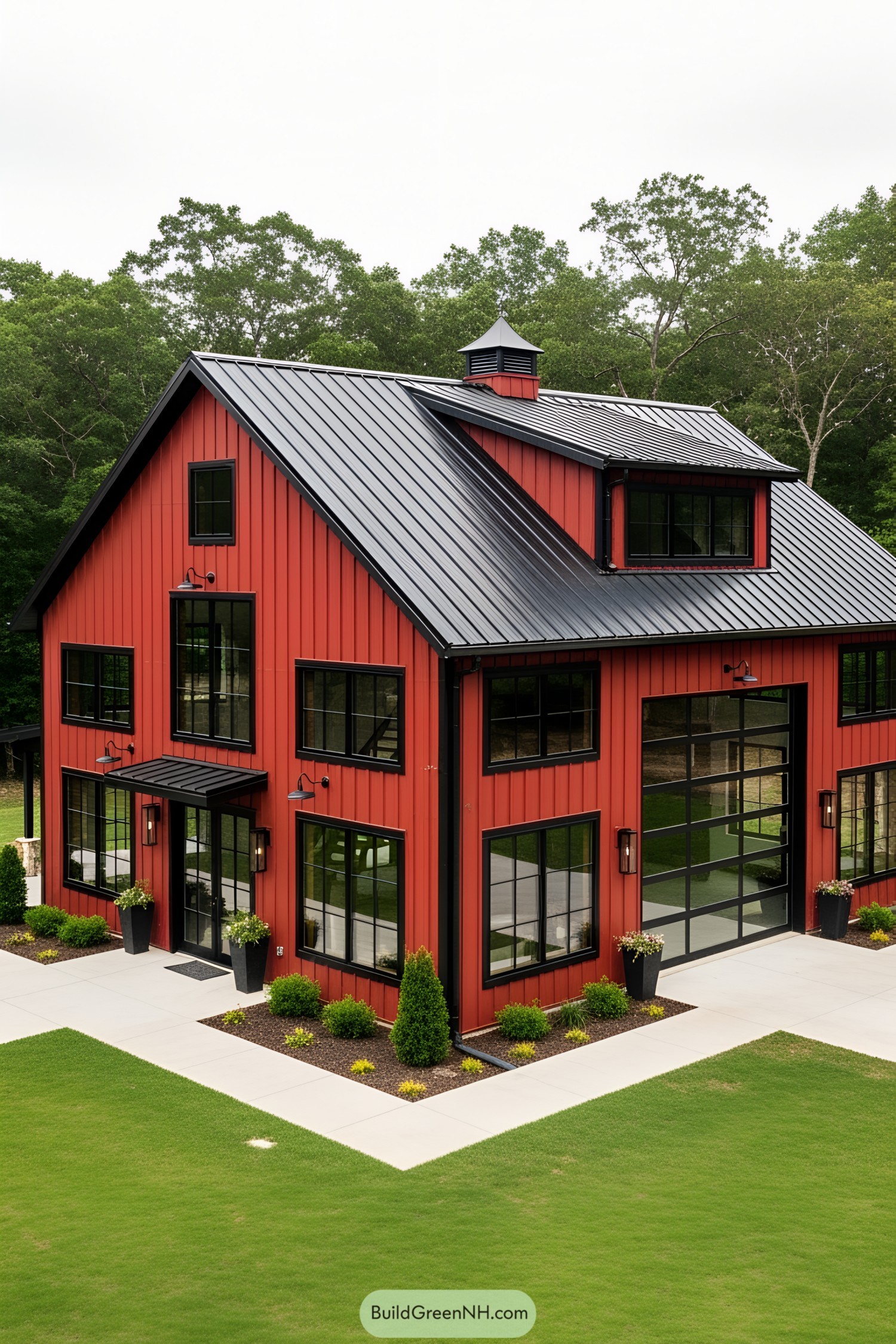 Red barndominium with black roof and large windows