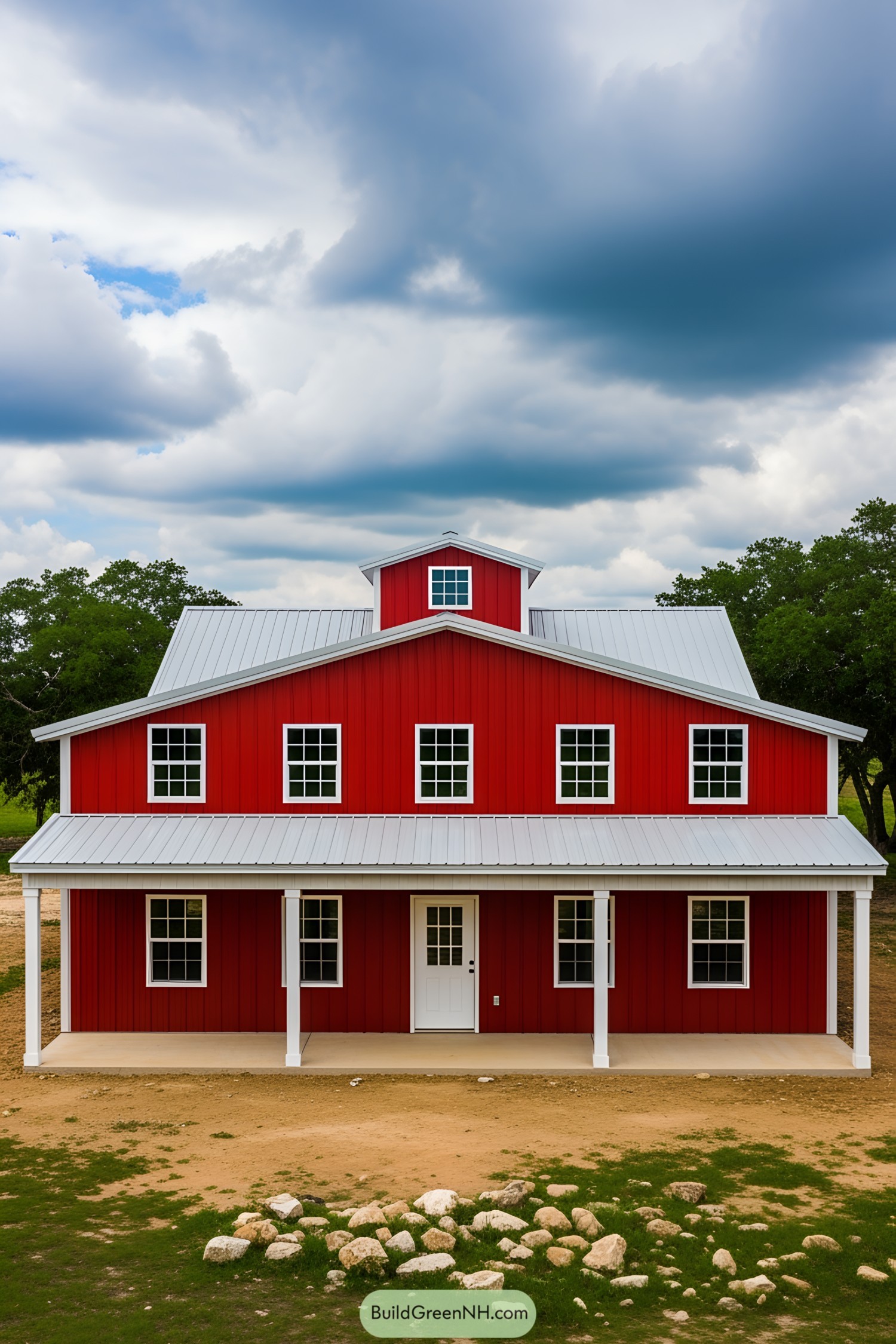 Bright red barndominium with a white porch and metal roof