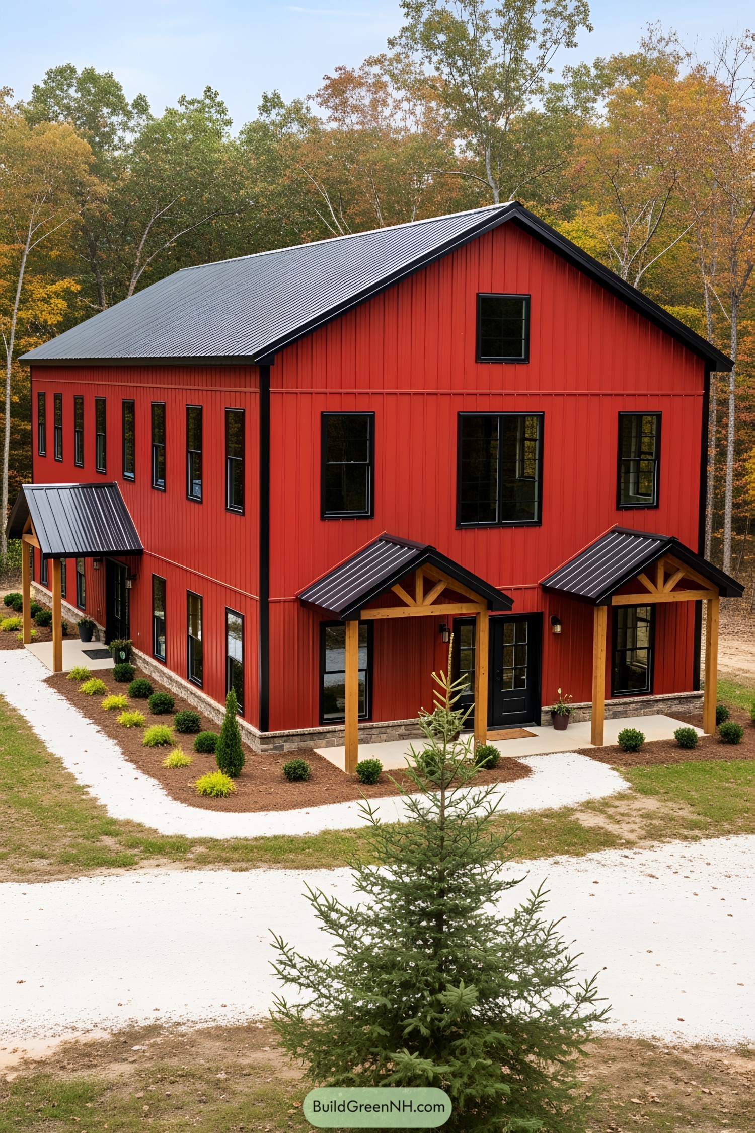 Red barndominium surrounded by trees