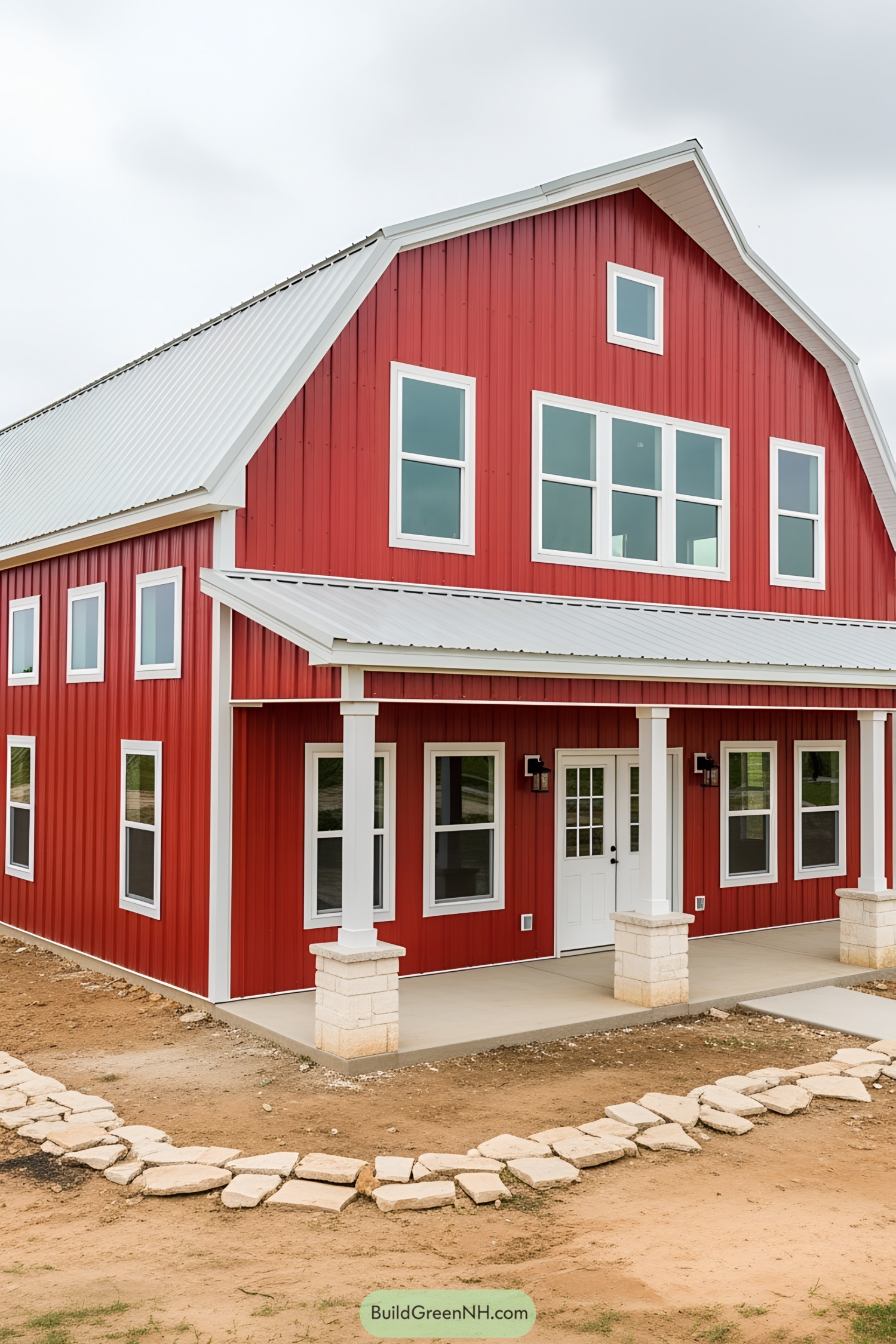 Red barndominium with white trim and multiple windows