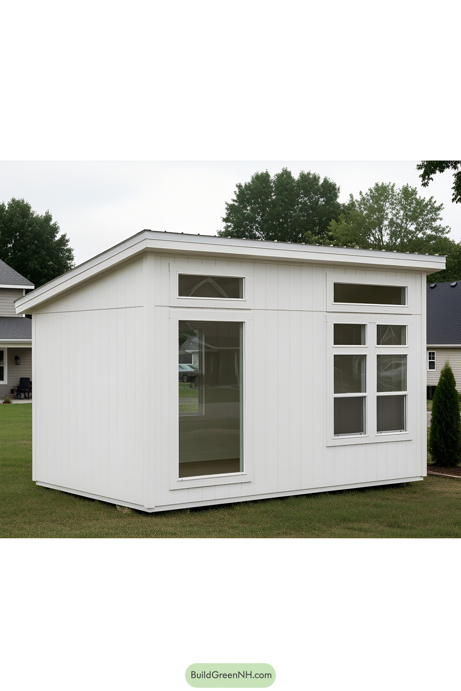 Small white shed office with large windows