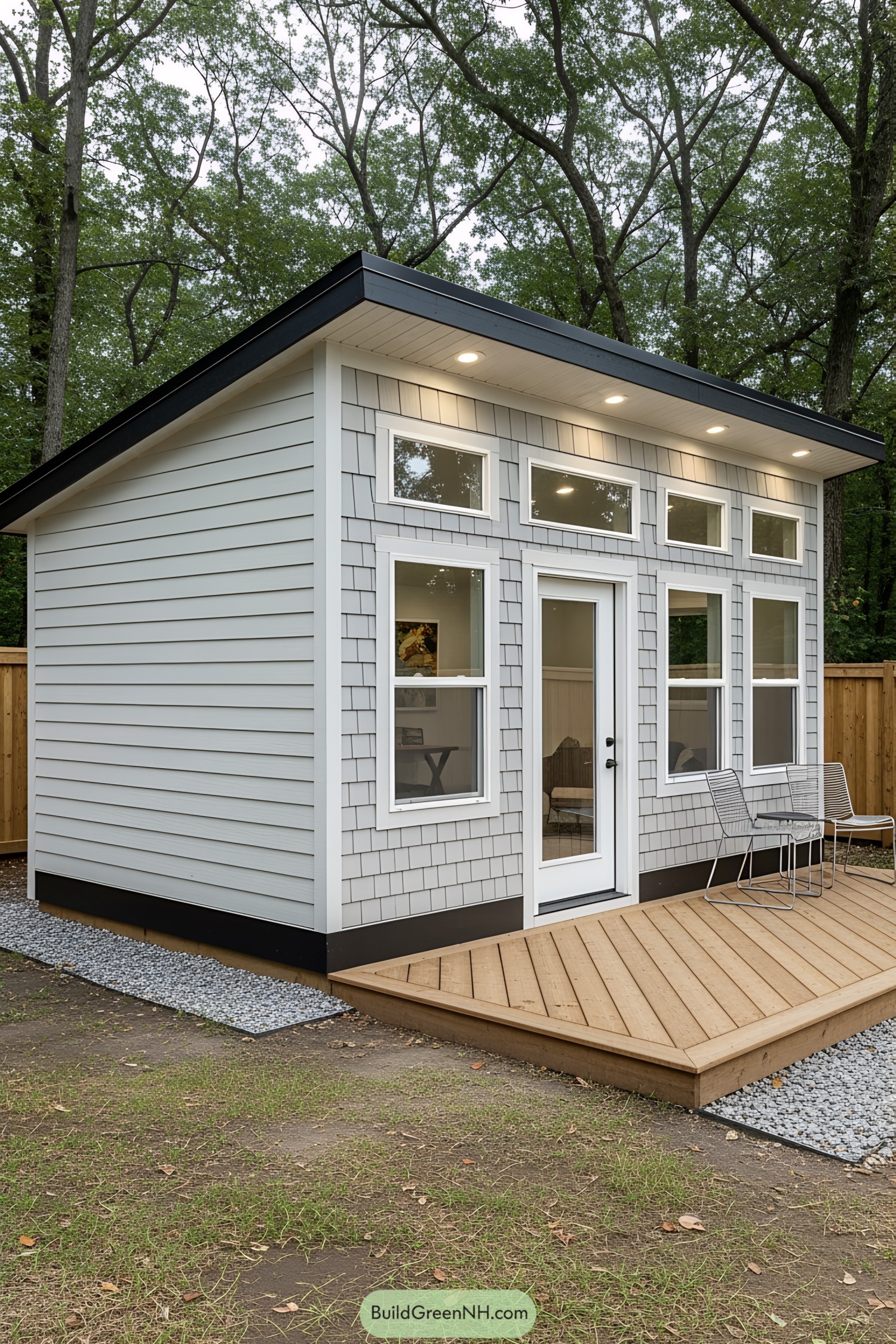 Small modern office shed with large windows and wooden deck