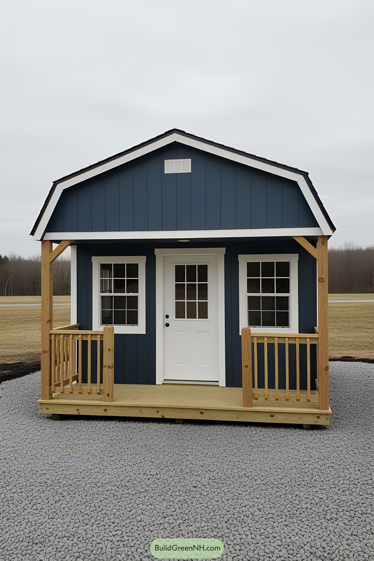 Small blue shed with a front porch and two windows