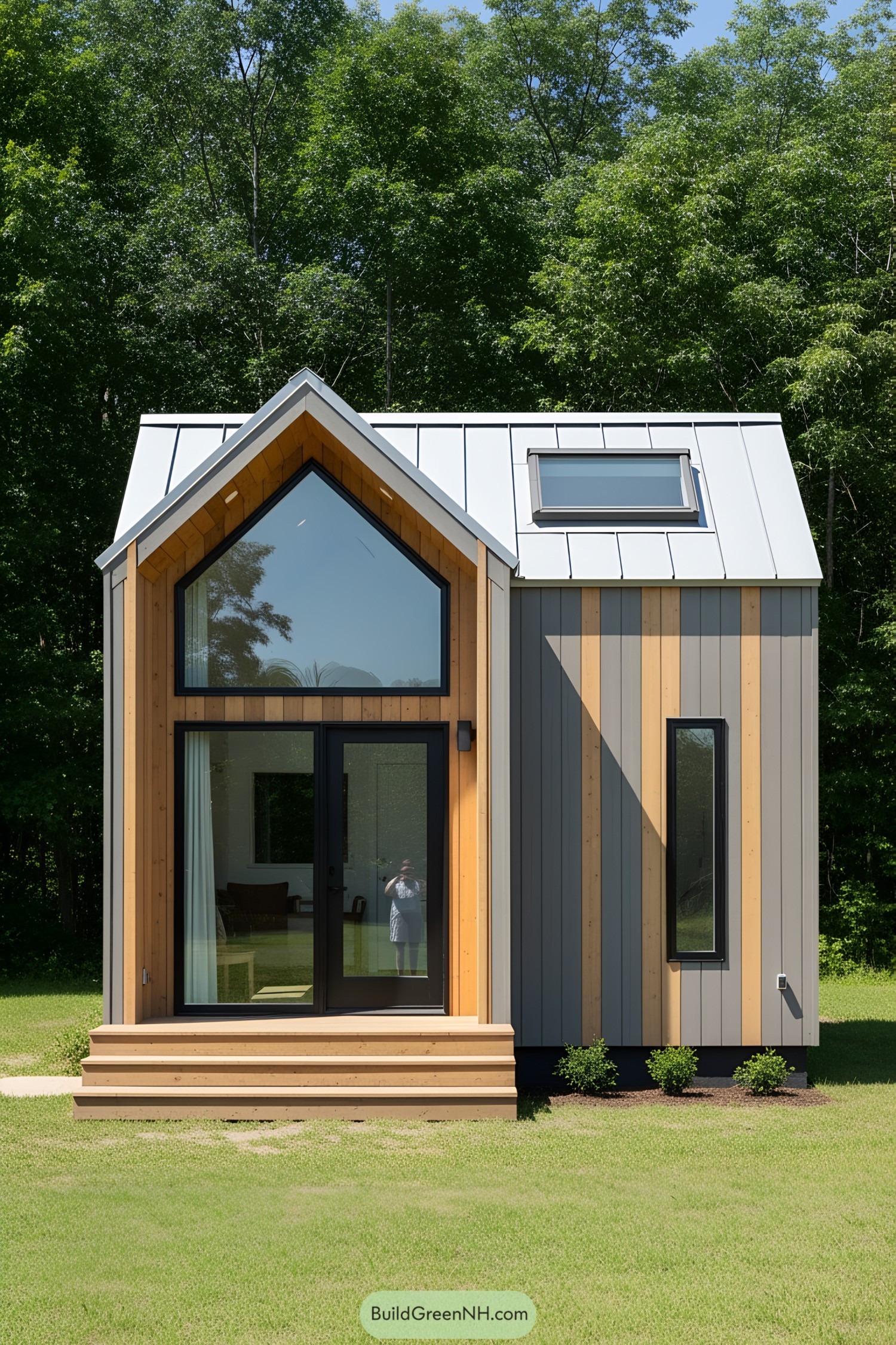 Tiny house with large windows surrounded by trees