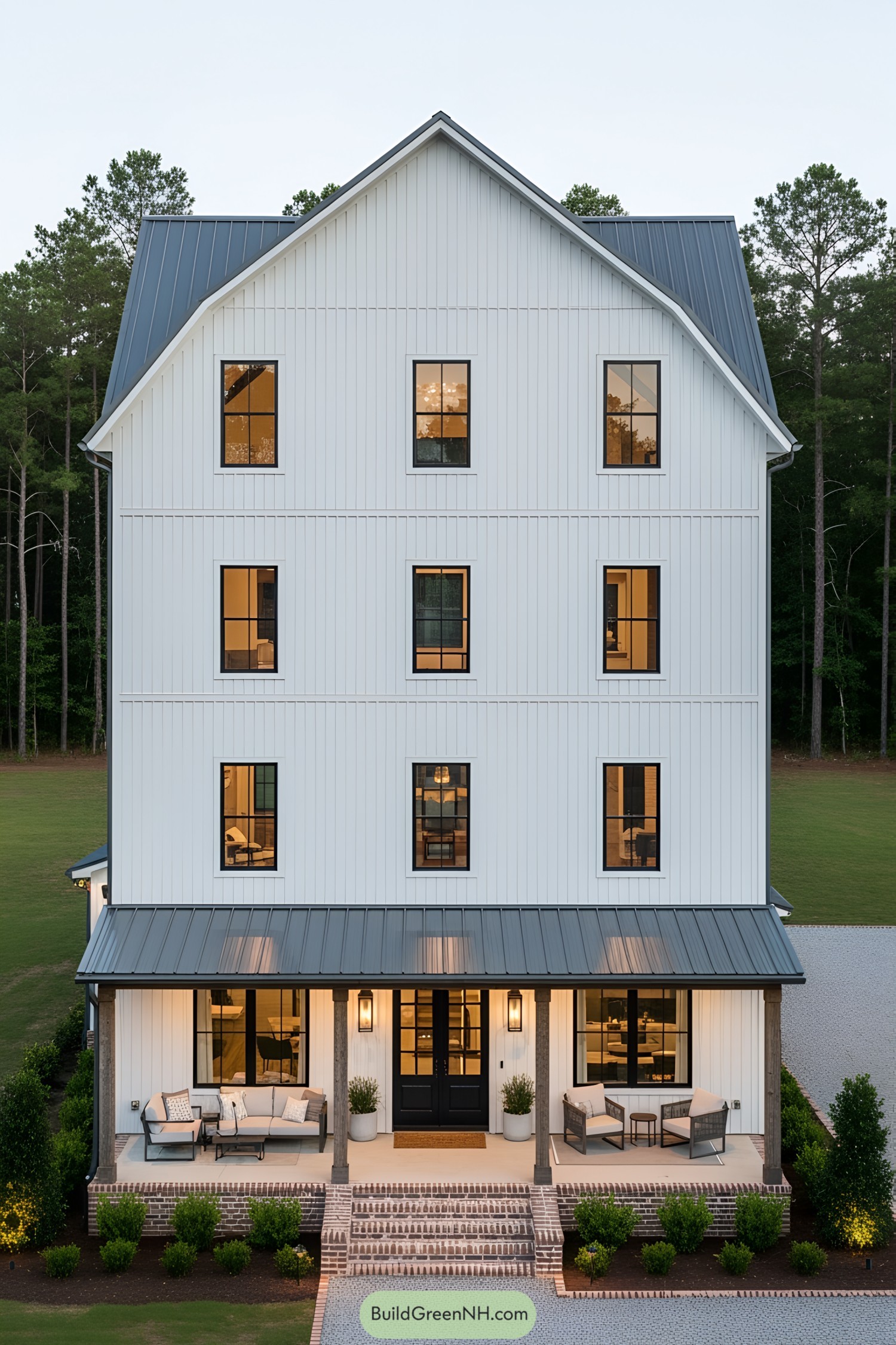 Tall white barndominium with multiple floors and large windows