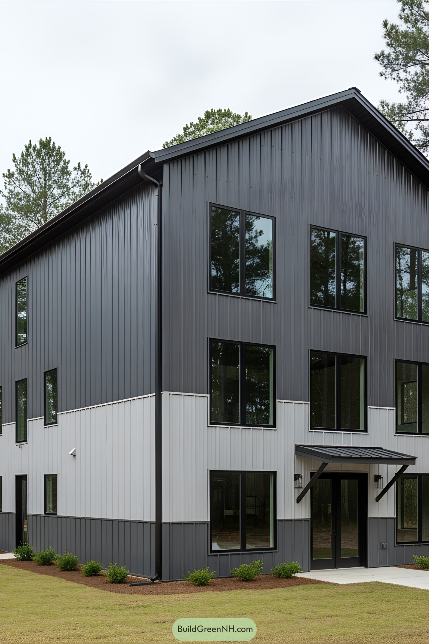 Modern barndominium with metal cladding and large windows