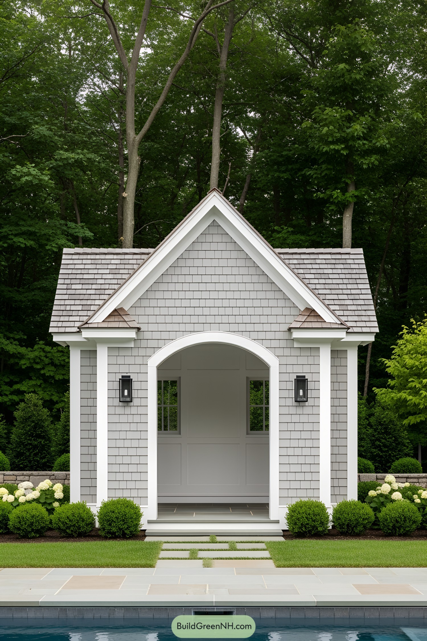 Tiny pool house with a gabled roof and gray shingles