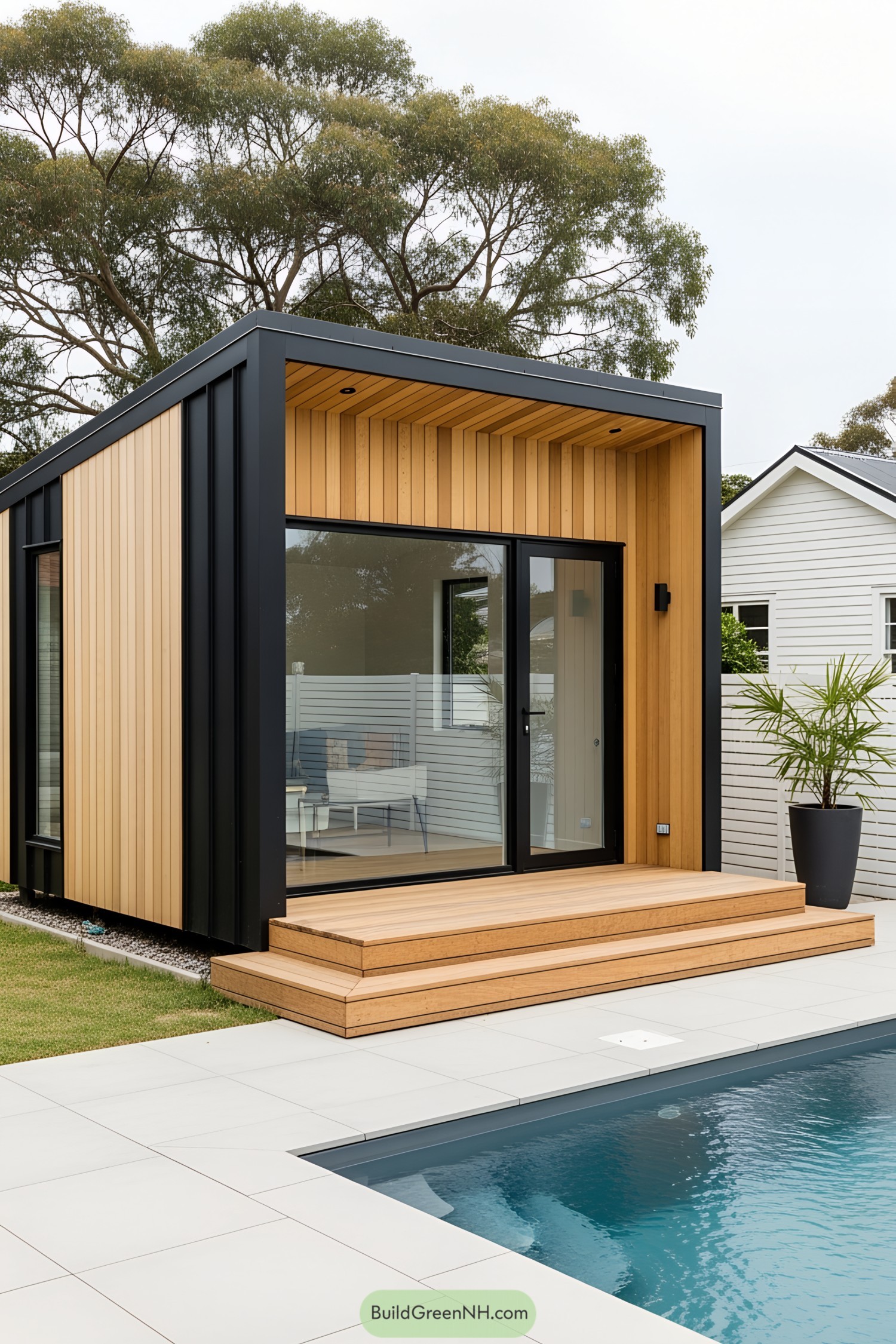 Compact, modern pool house with wood and glass accents