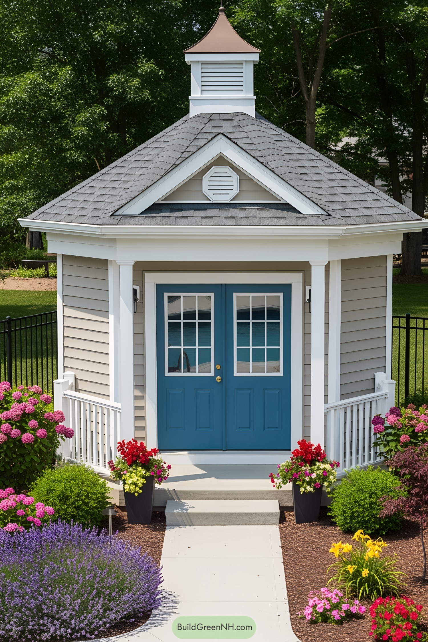 Tiny hexagonal pool house with blue doors, surrounded by colorful flowers
