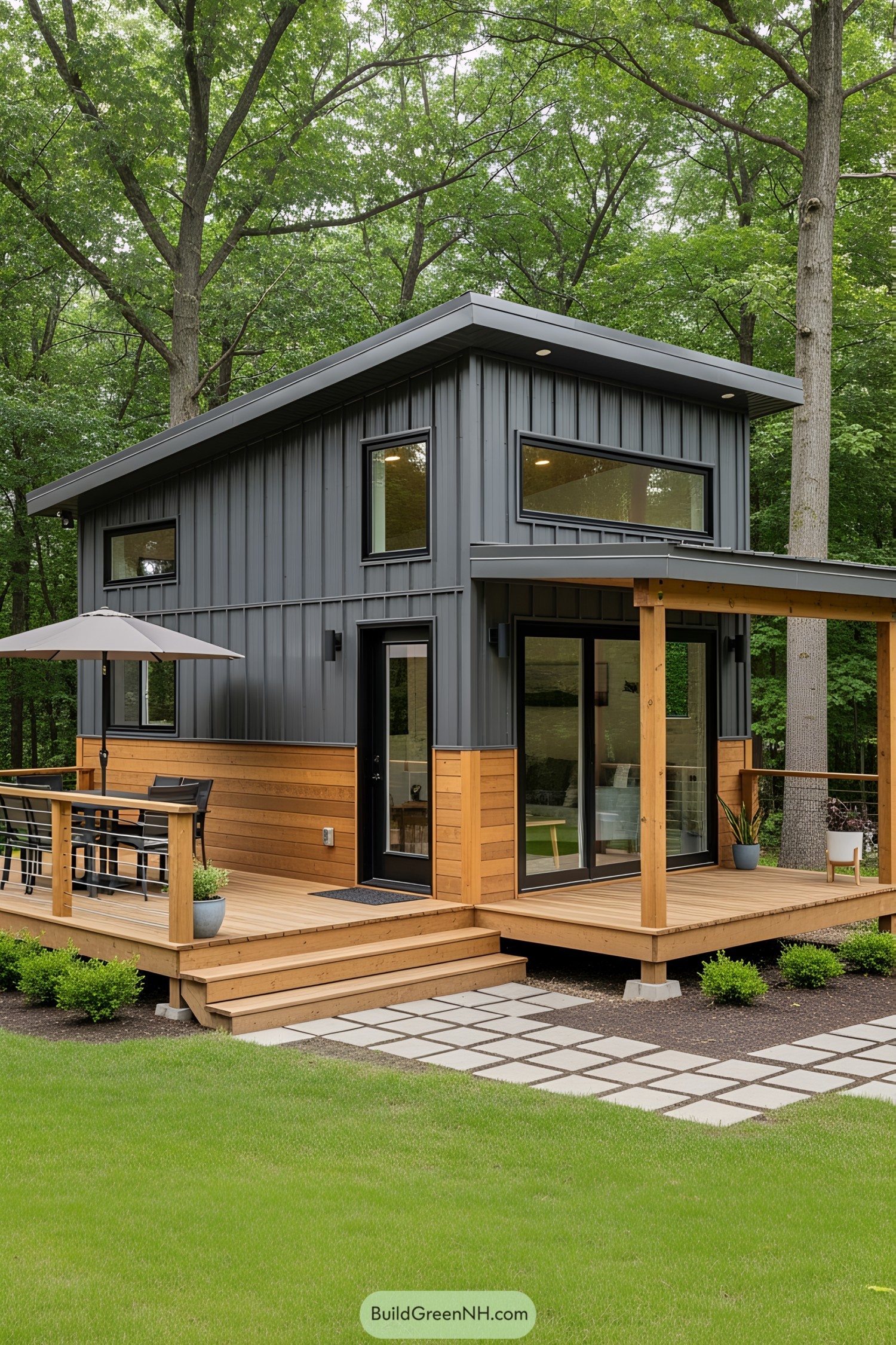 Compact modern house with a wooden deck in a forest setting
