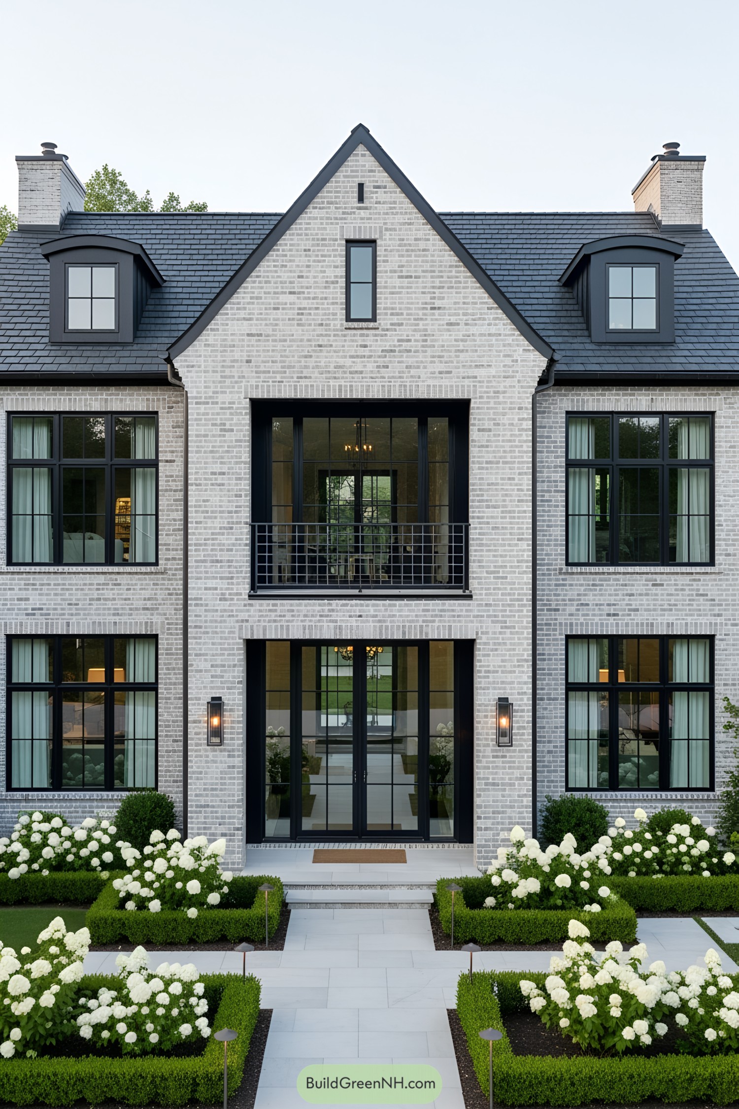 Modern brick house with black-framed windows and a manicured garden