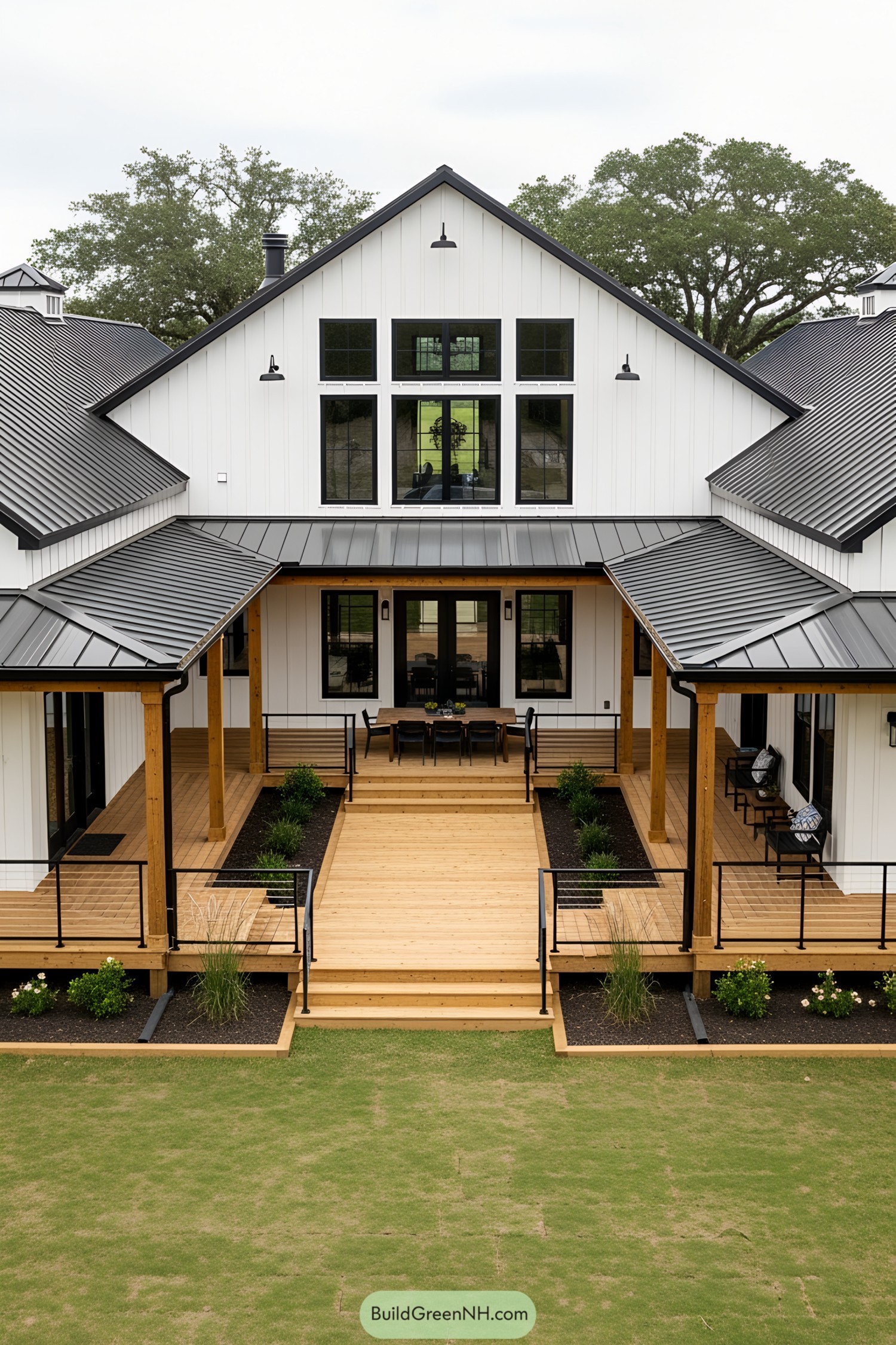 U-shaped barndominium with a spacious wooden deck and black metal roof