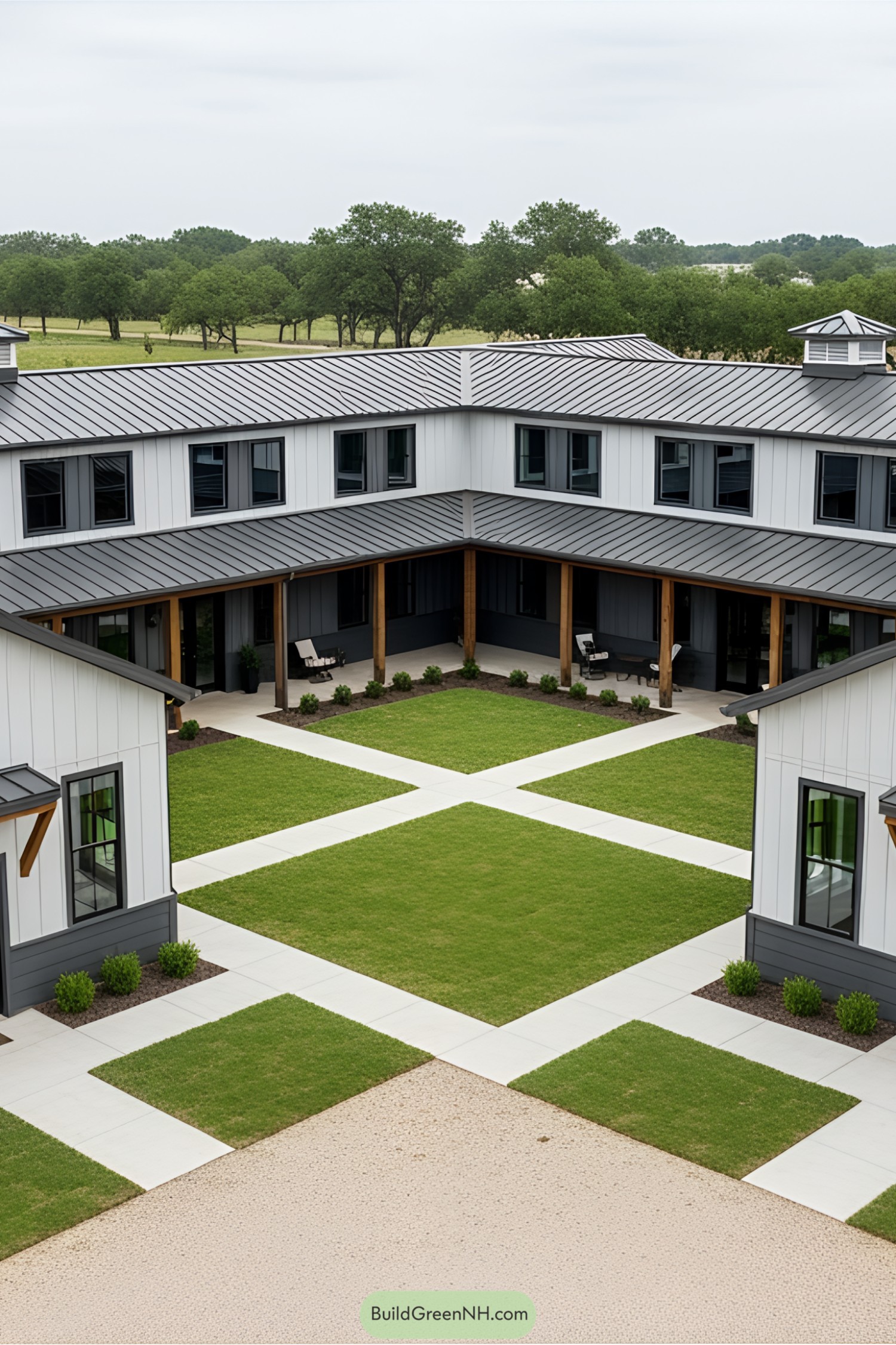 Modern U-shaped barndominium with lush green courtyard
