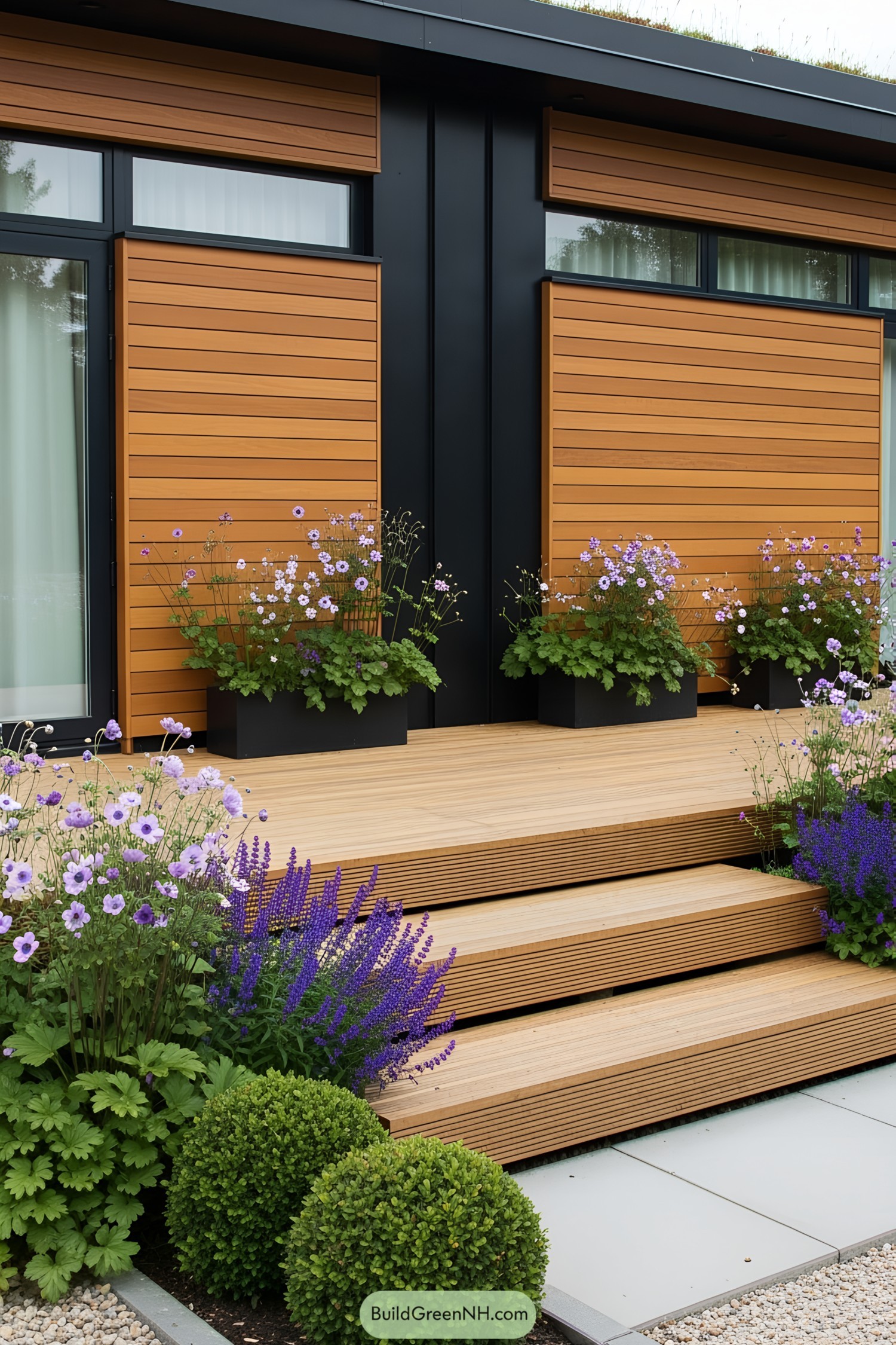 Tiny house with wooden deck and vibrant flower garden
