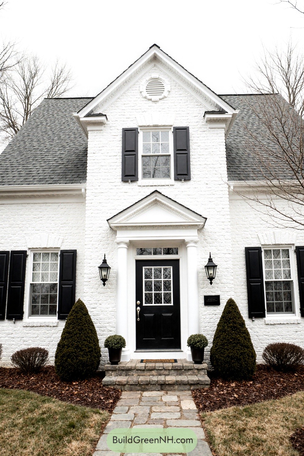 Charming white brick house with dark shutters
