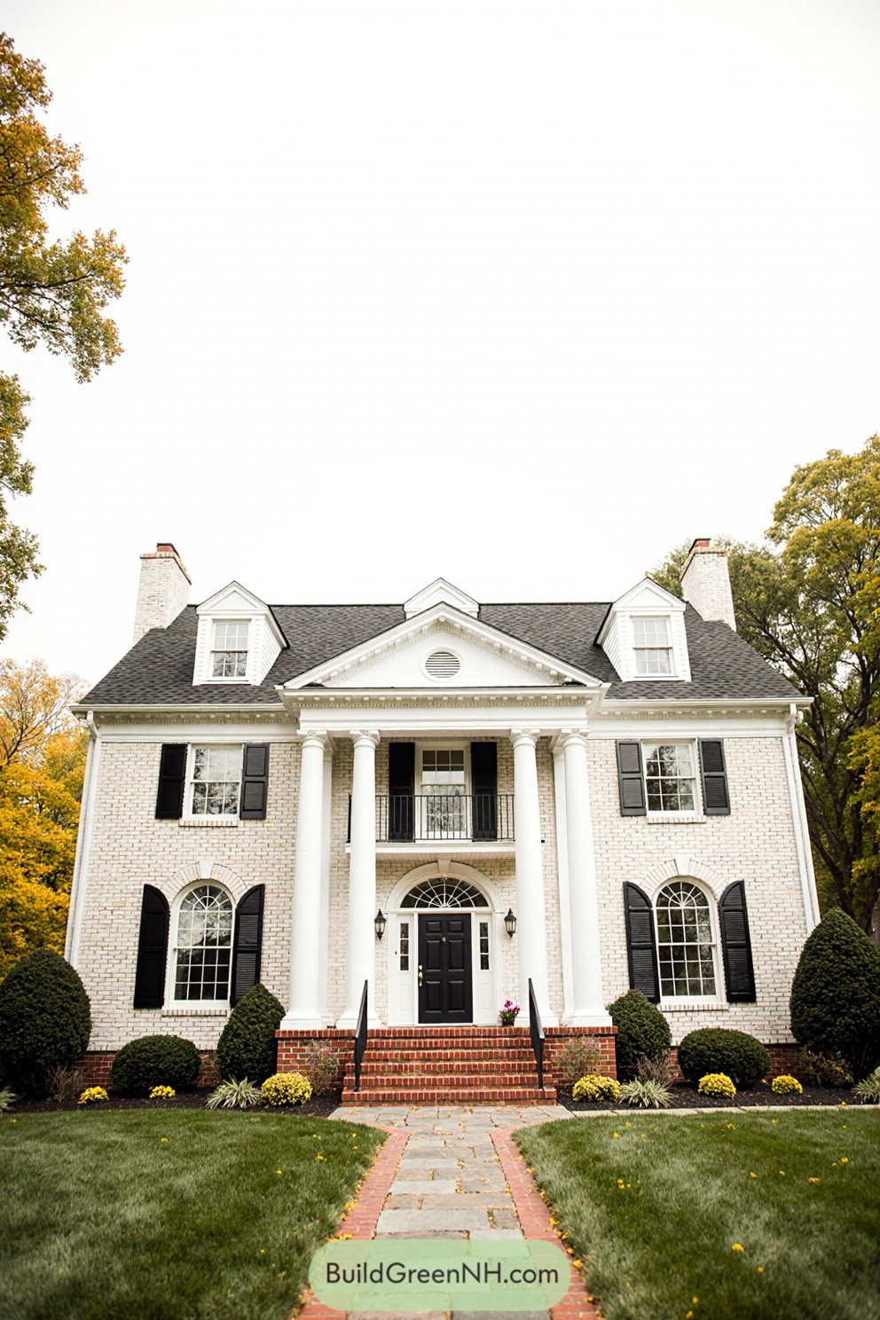 Classic white brick house with black shutters and grand columns