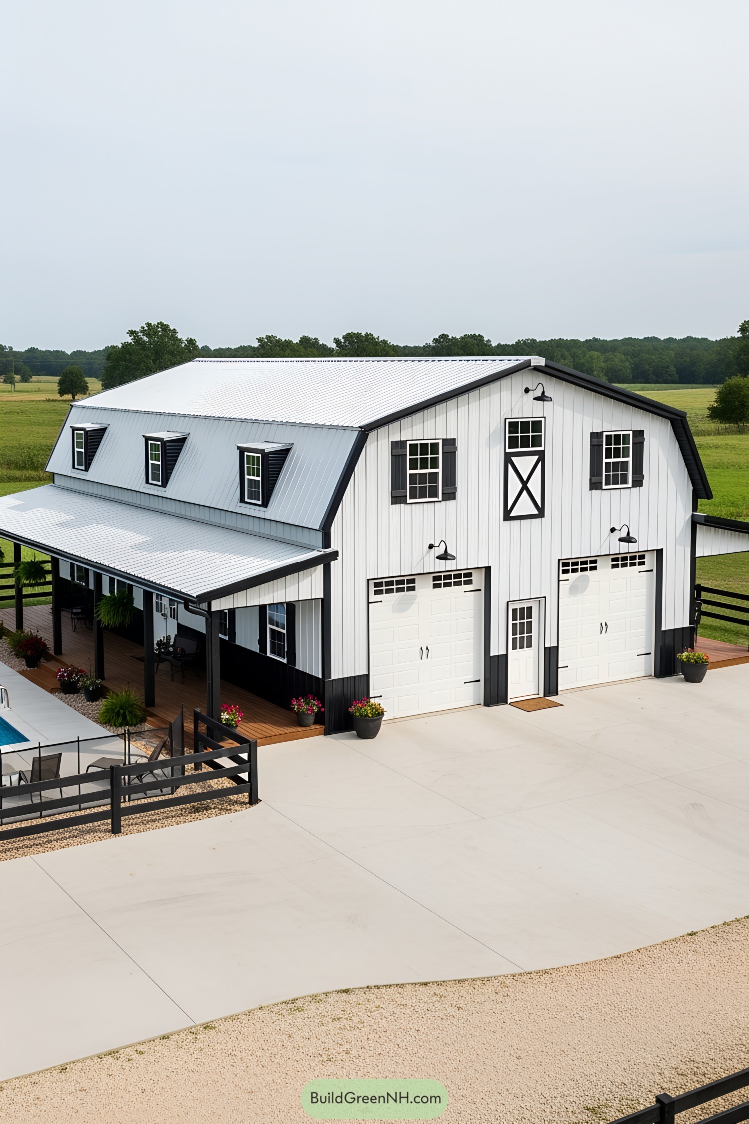 Modern white and black barndominium with a spacious porch and inviting driveway