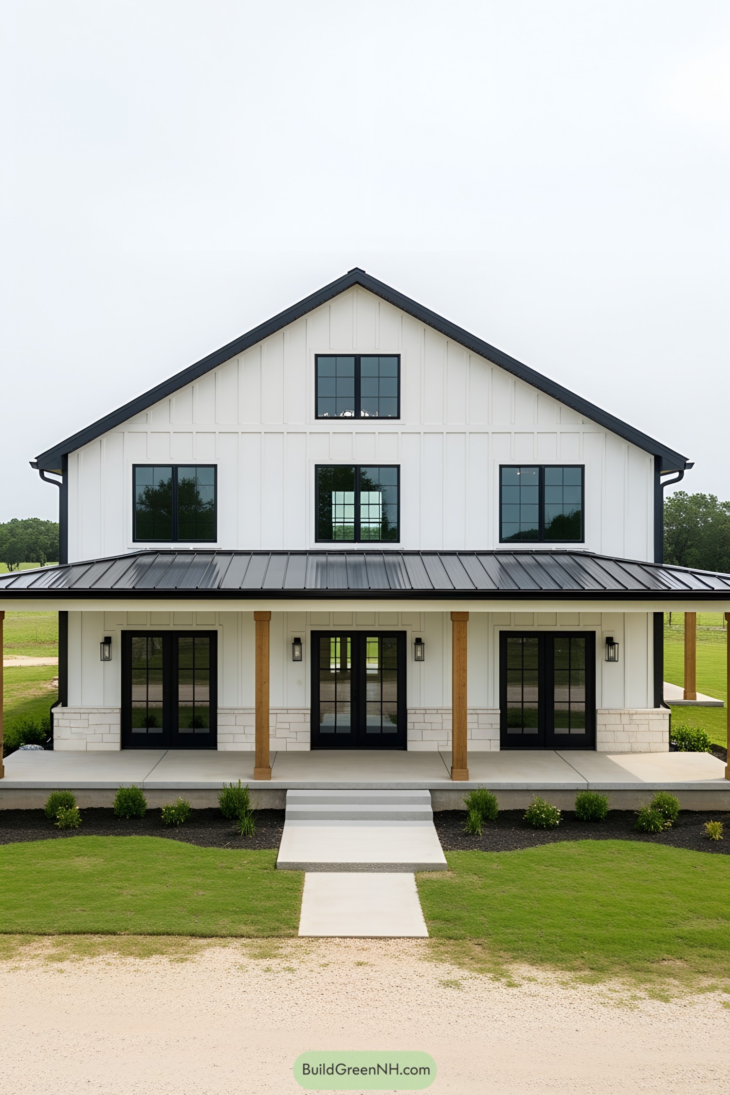 Modern white barndominium with black accents and wooden columns