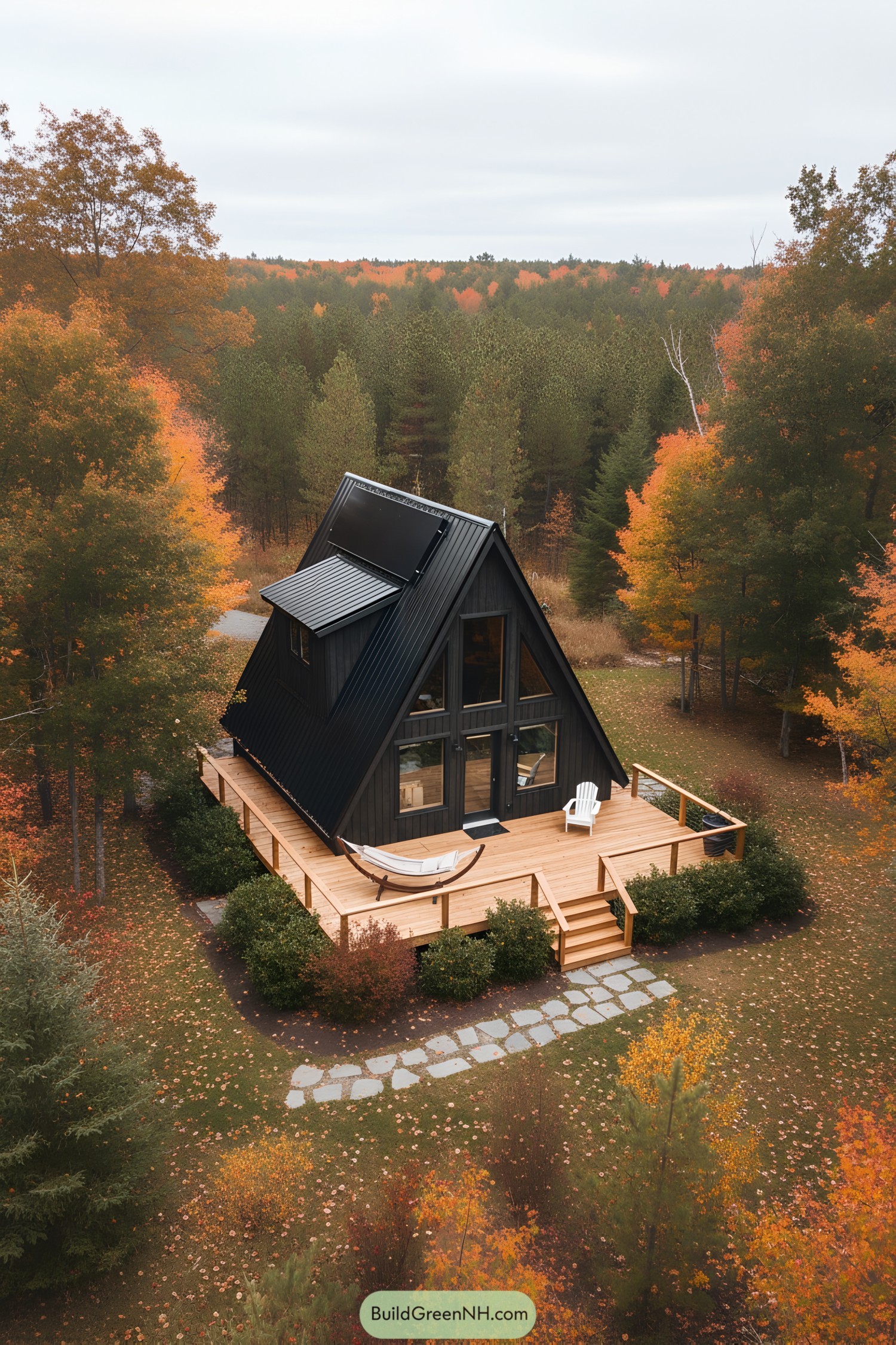 A-frame cabin with large deck and hammock in fall setting