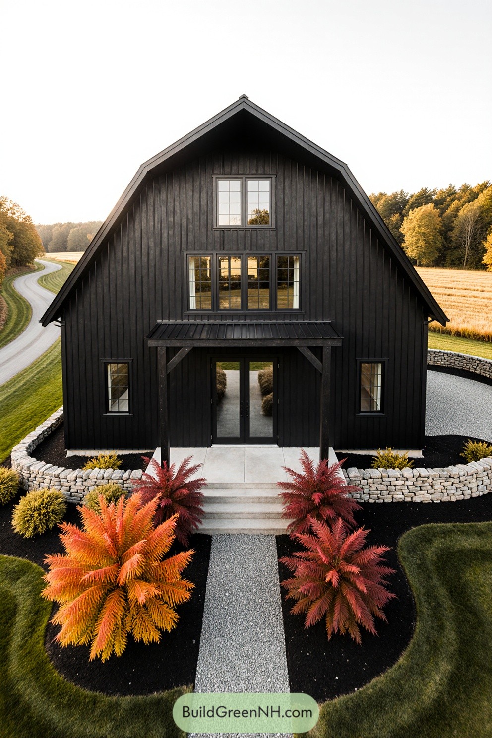 Black barndominium surrounded by vibrant autumn foliage
