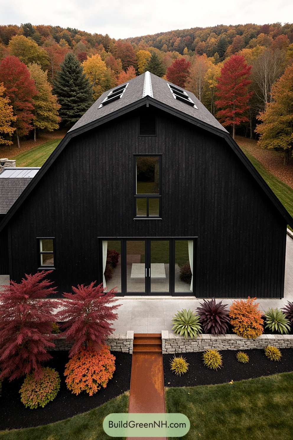 Black barndominium with colorful foliage