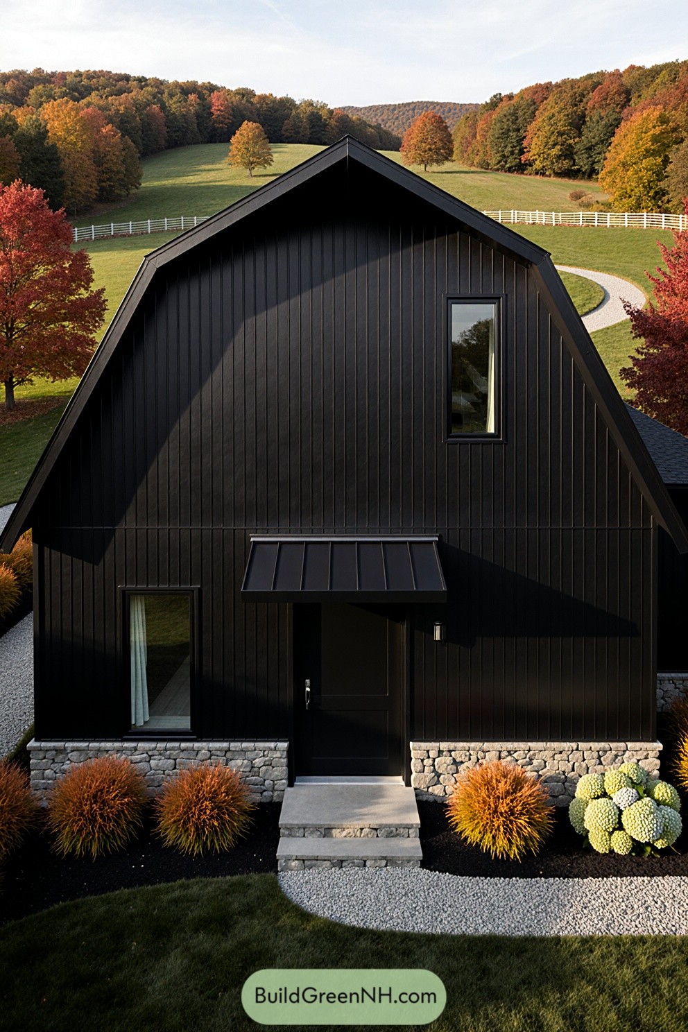 Black barndominium surrounded by vibrant autumn foliage