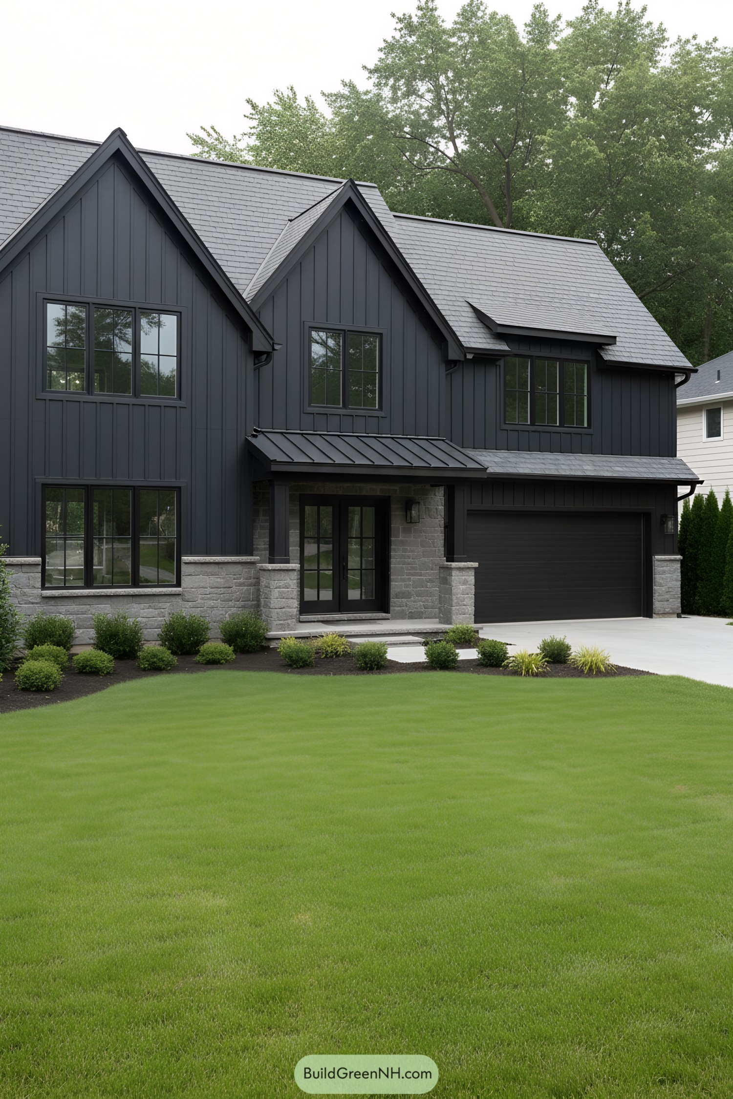 Black suburban house with a stone facade and manicured lawn