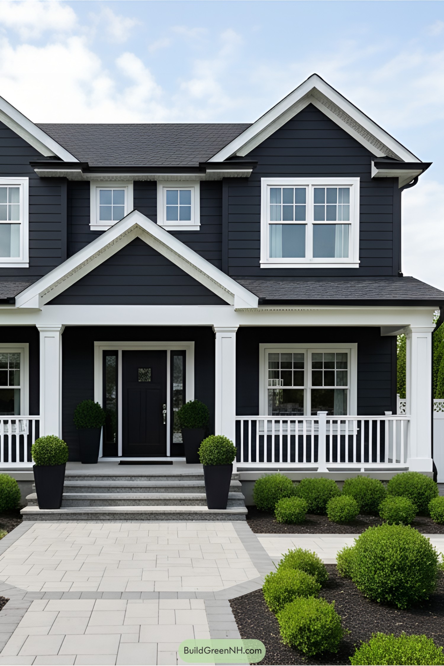 Two-story black house with white accents