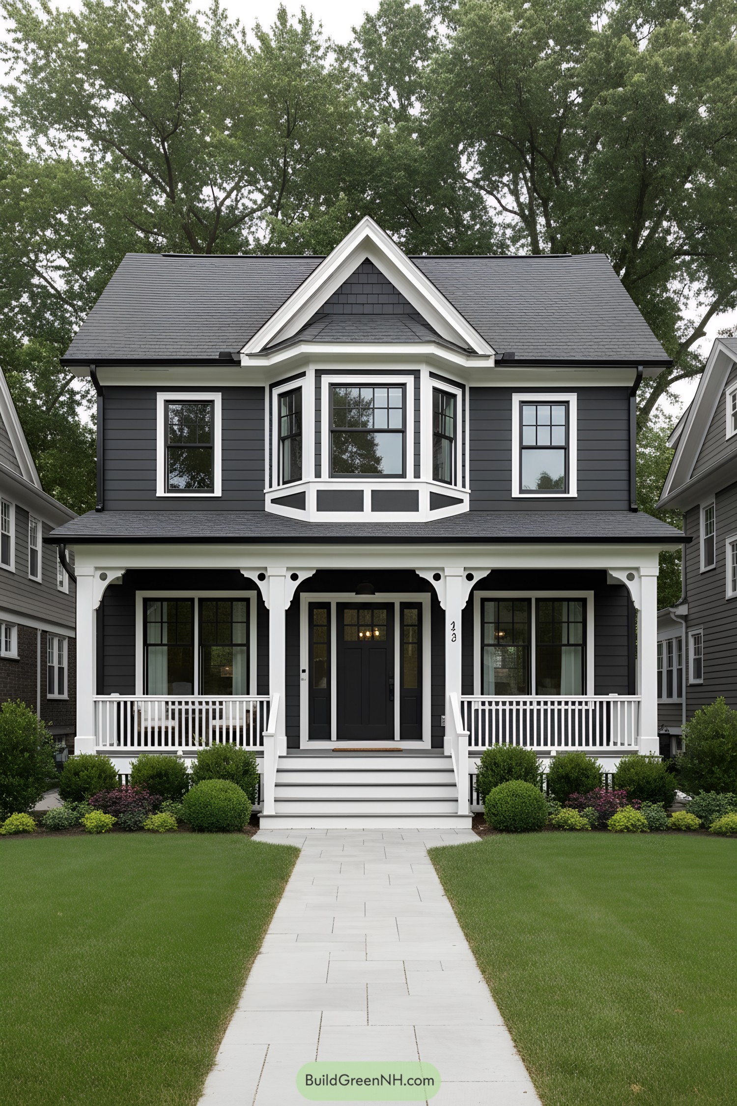 A sophisticated black house with white trim and a welcoming porch