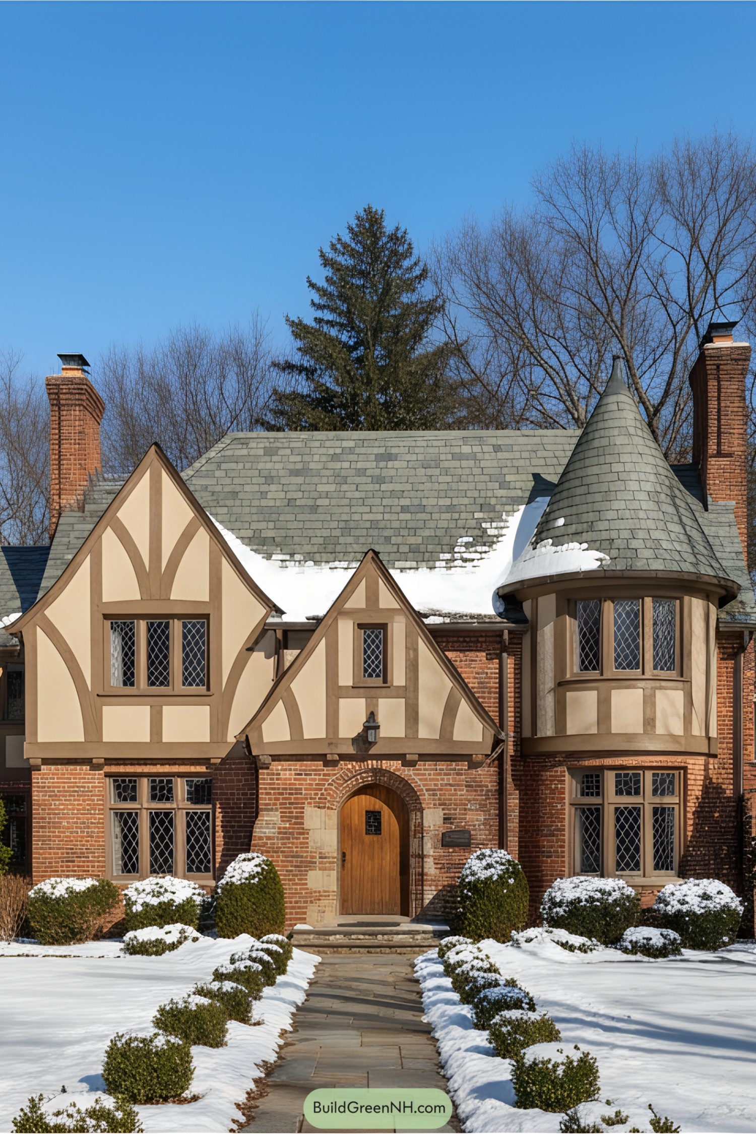 Brick cottage with decorative half-timbering and snow on the roof