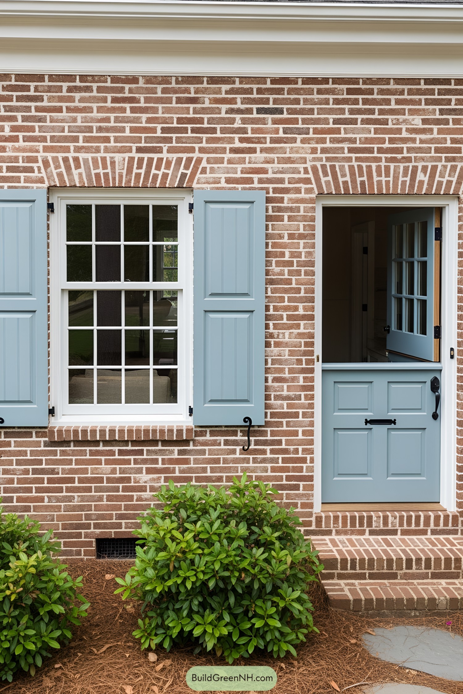 Brick house facade featuring blue shutters and a matching door