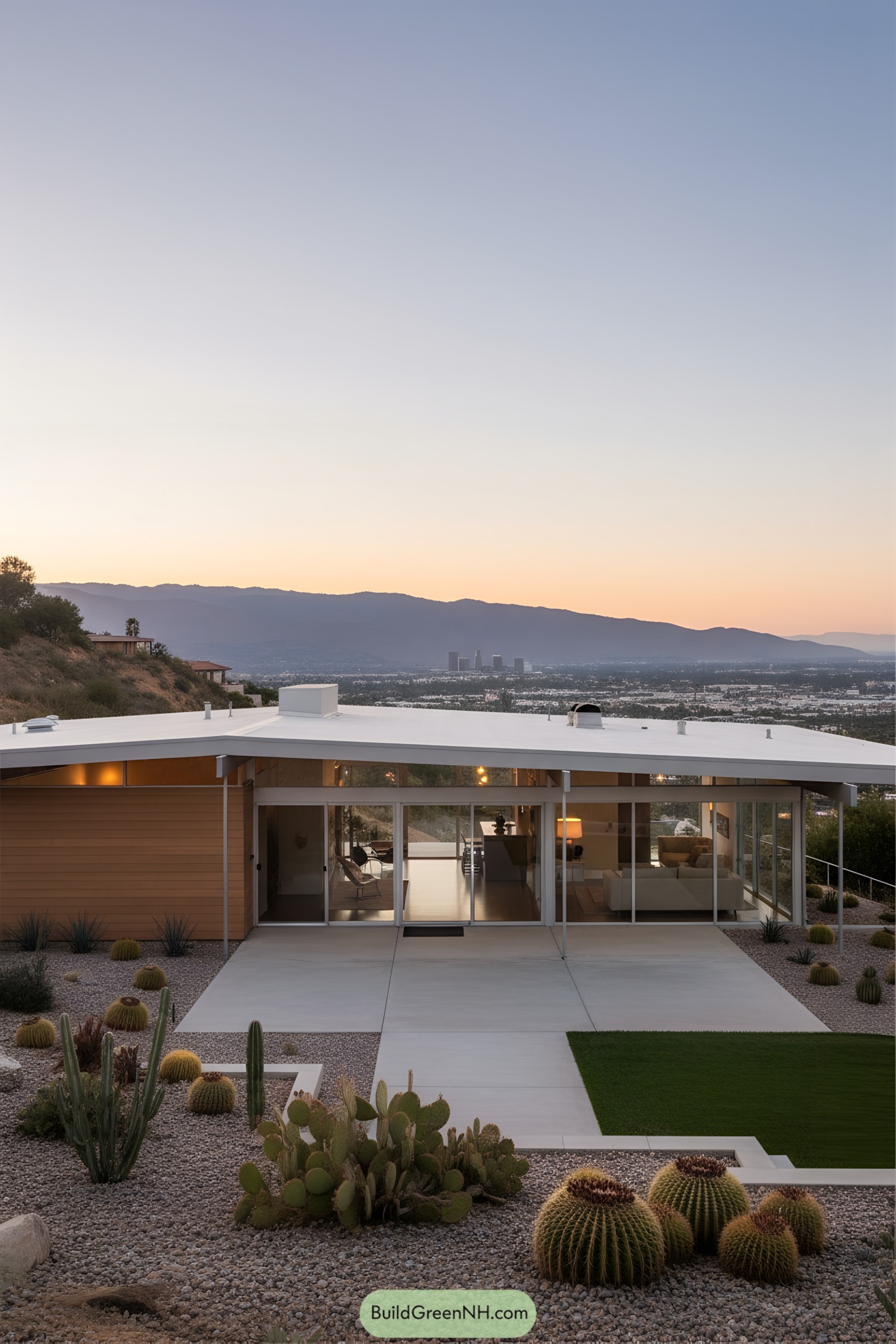 Flat-roofed house with glass walls and desert landscaping