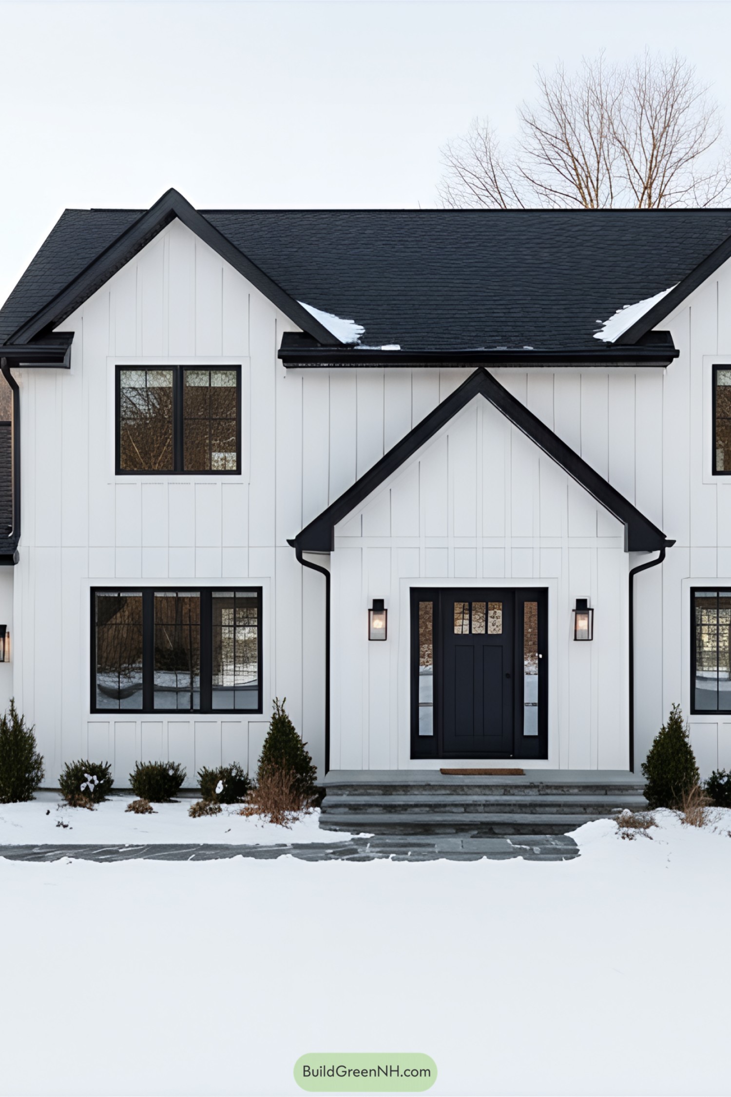 Modern suburban house with snow-covered lawn