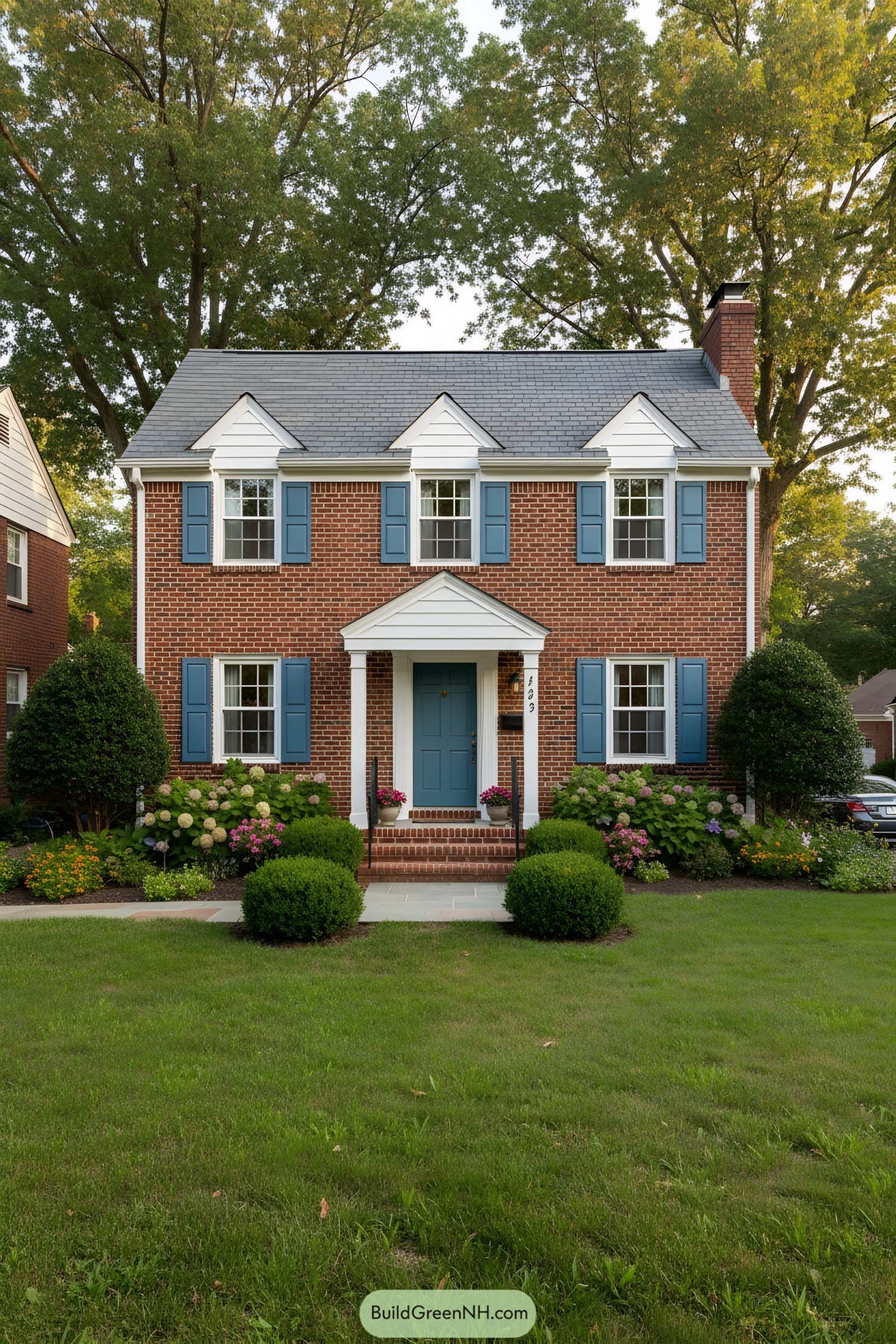 Charming brick house with blue shutters and lush garden
