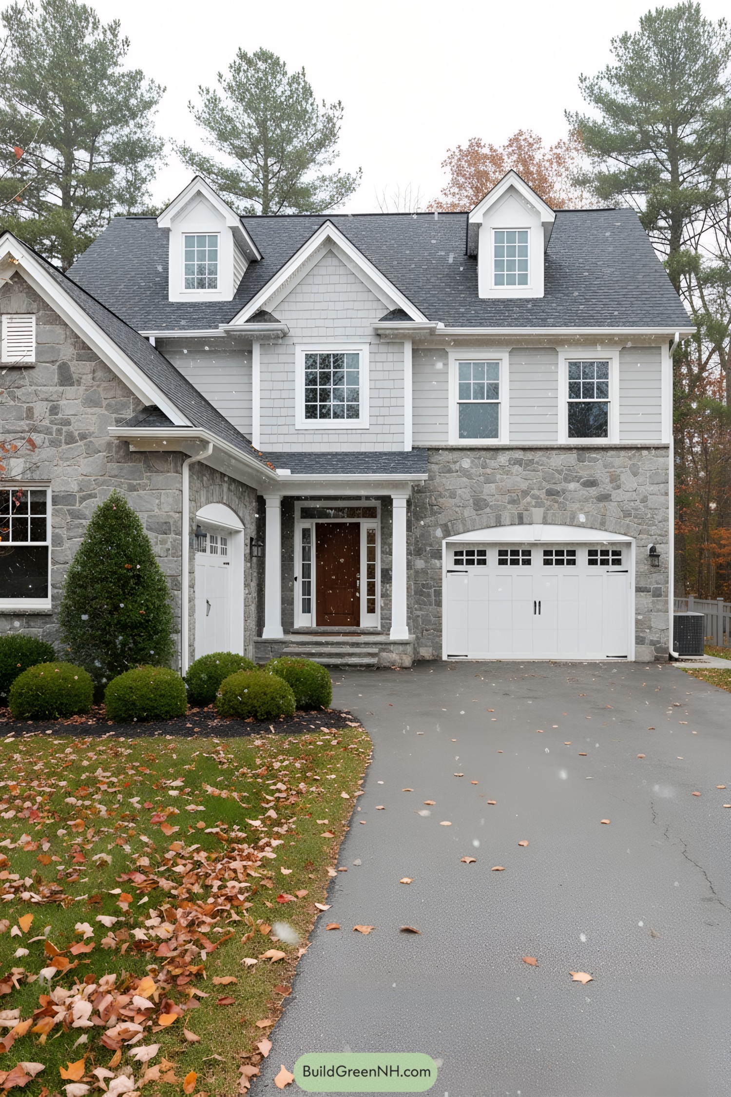 Stone house in suburb with autumn leaves and a cloudy sky
