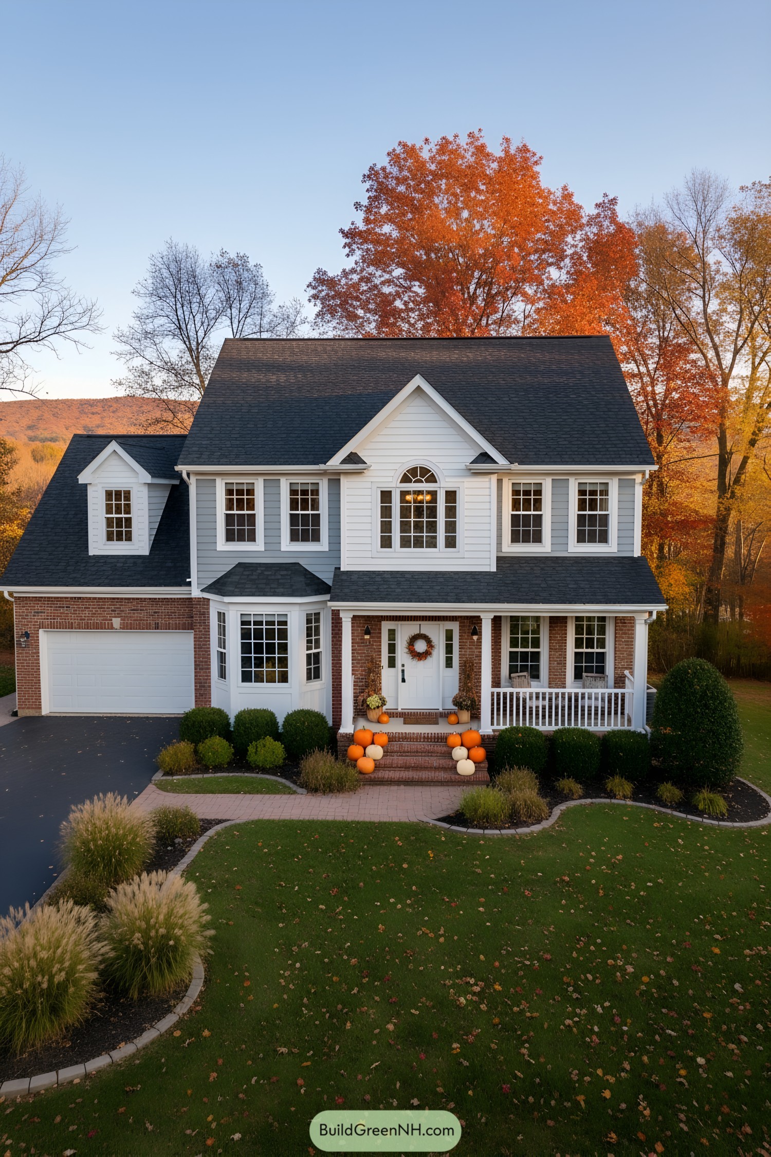 Colonial house with pumpkins and fall trees