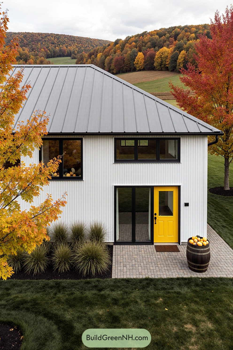 Modern white farmhouse with a pop of yellow and autumn trees
