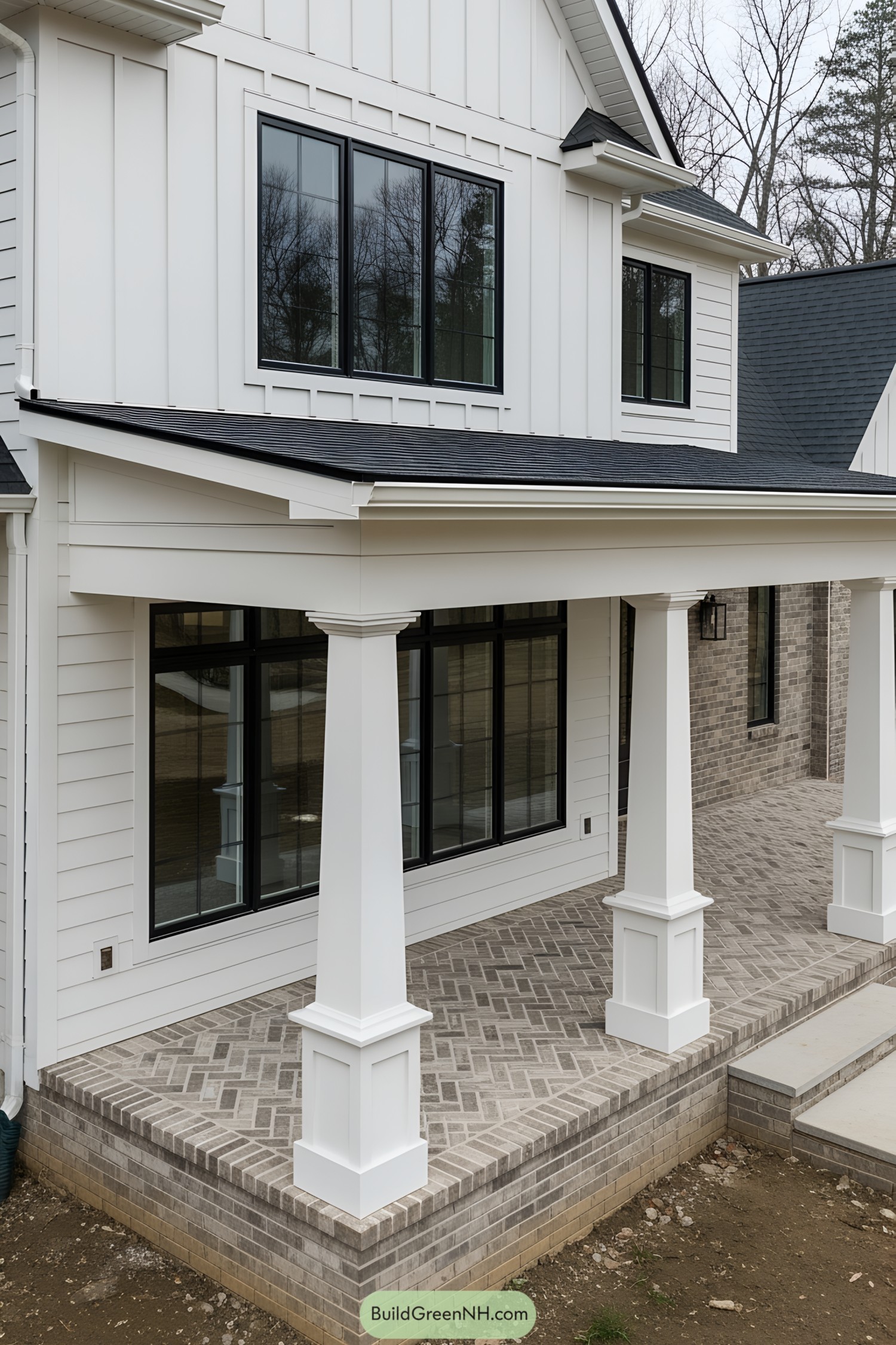 White porch with bold columns and large windows