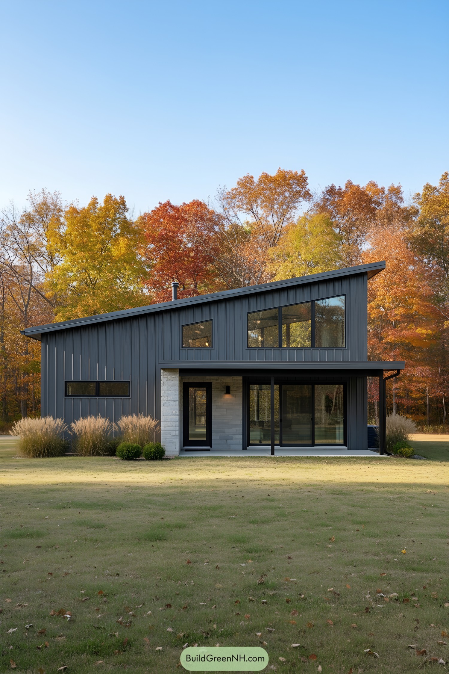 Stylish barndominium framed by colorful autumn trees