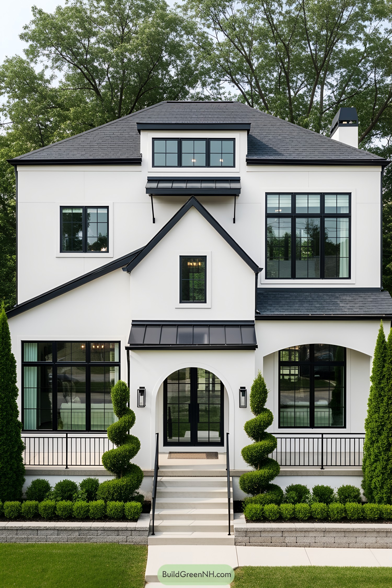 Modern cottage with a black and white facade and lush greenery